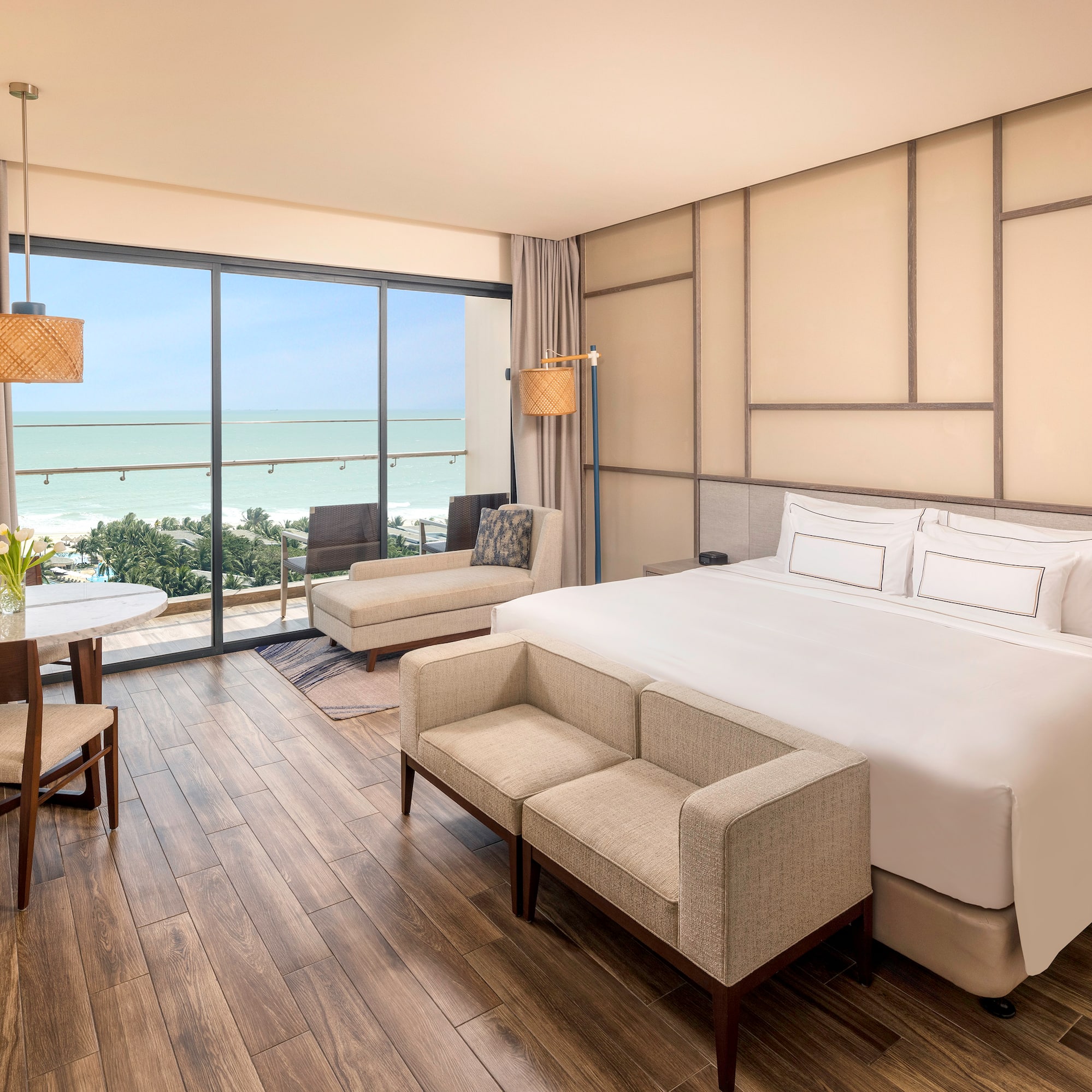 a room with a bed and chairs and a table