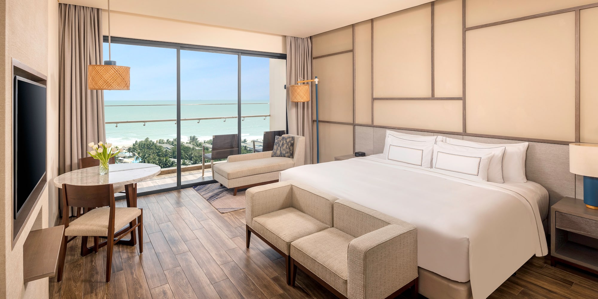 a room with a bed and chairs and a table