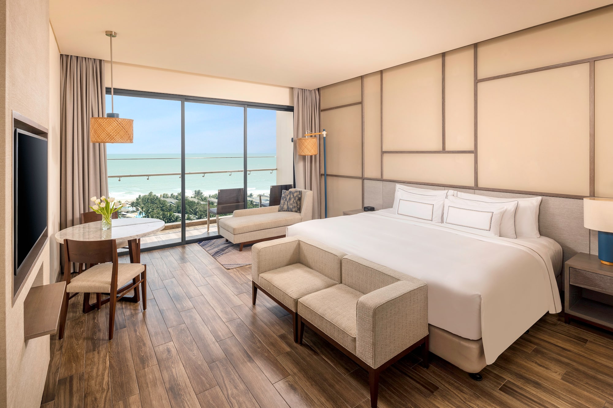 a room with a bed and chairs and a table