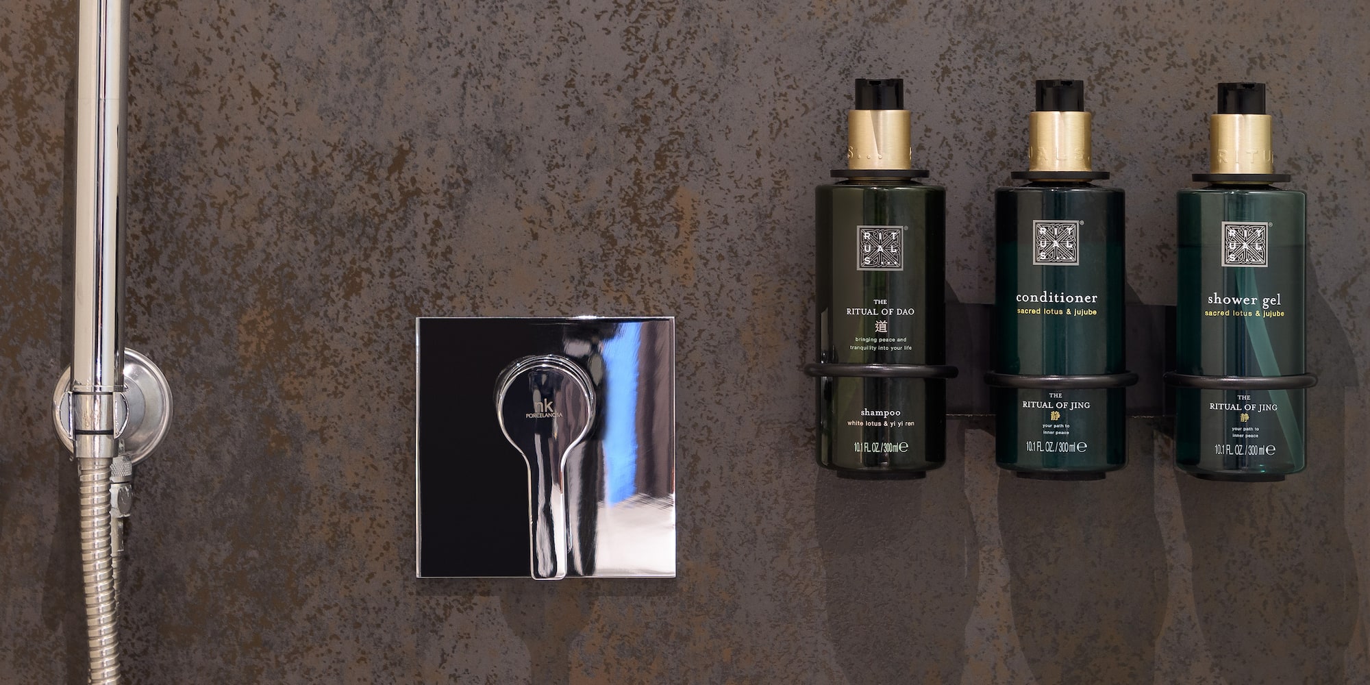 a group of green bottles next to a silver mirror