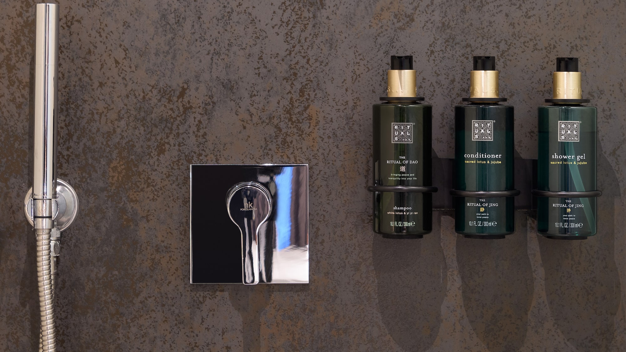 Modern shower with Rituals bath products: shampoo, conditioner, shower gel.