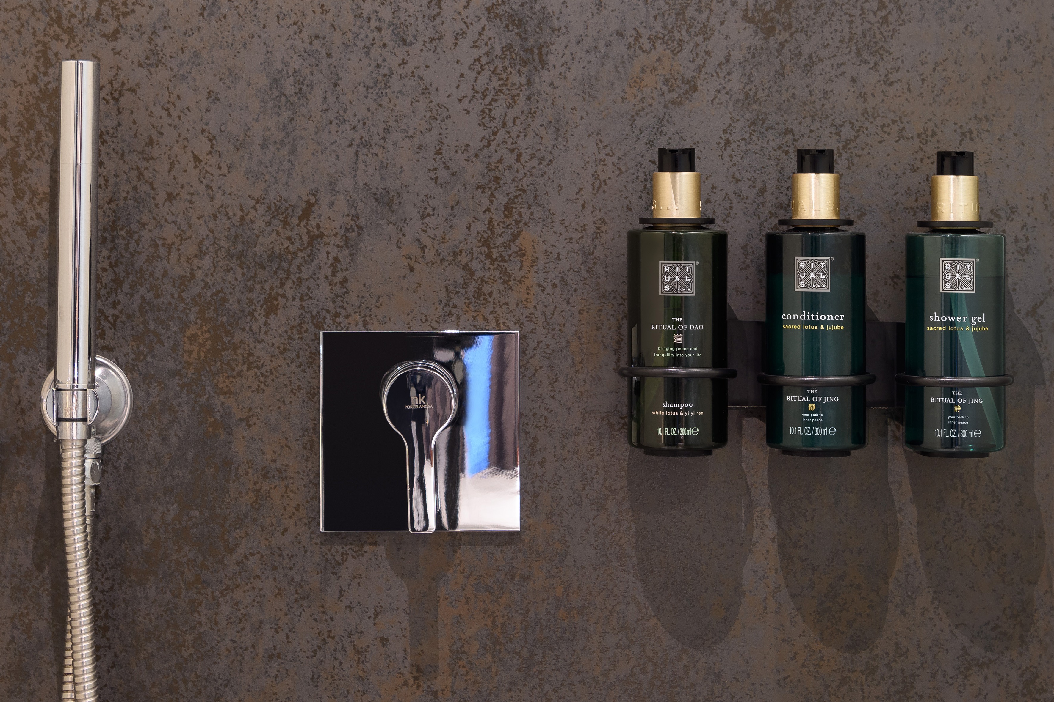 Modern shower with Rituals bath products: shampoo, conditioner, shower gel.