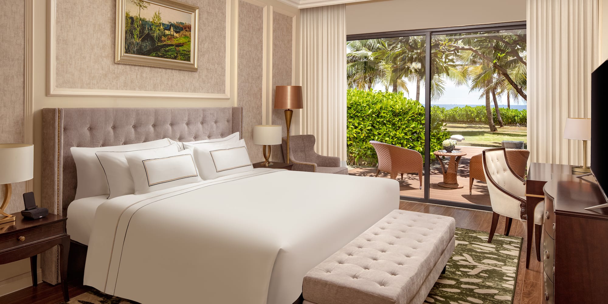 a bedroom with a large bed and a glass door