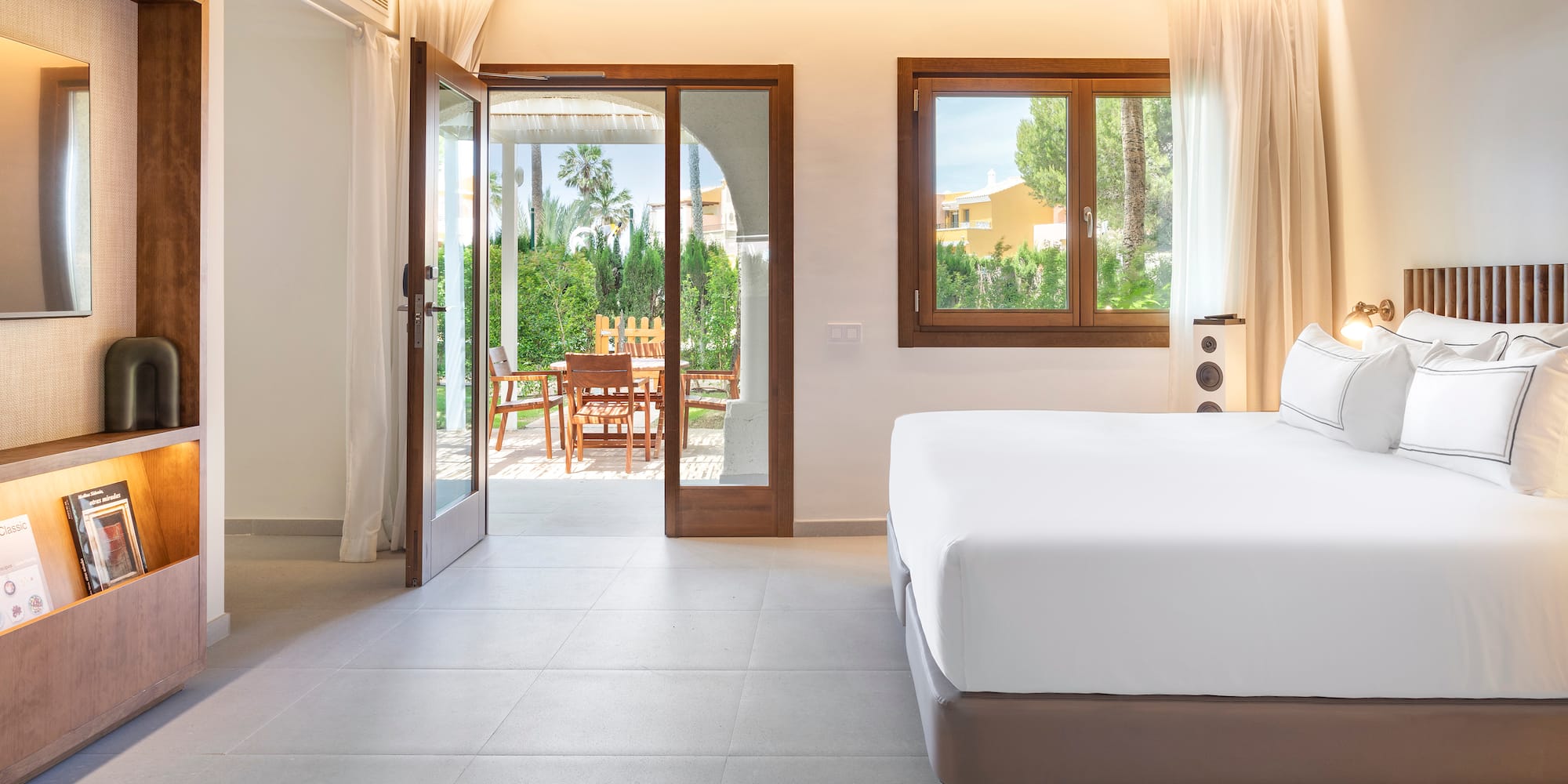 a bedroom with a bed and a glass door