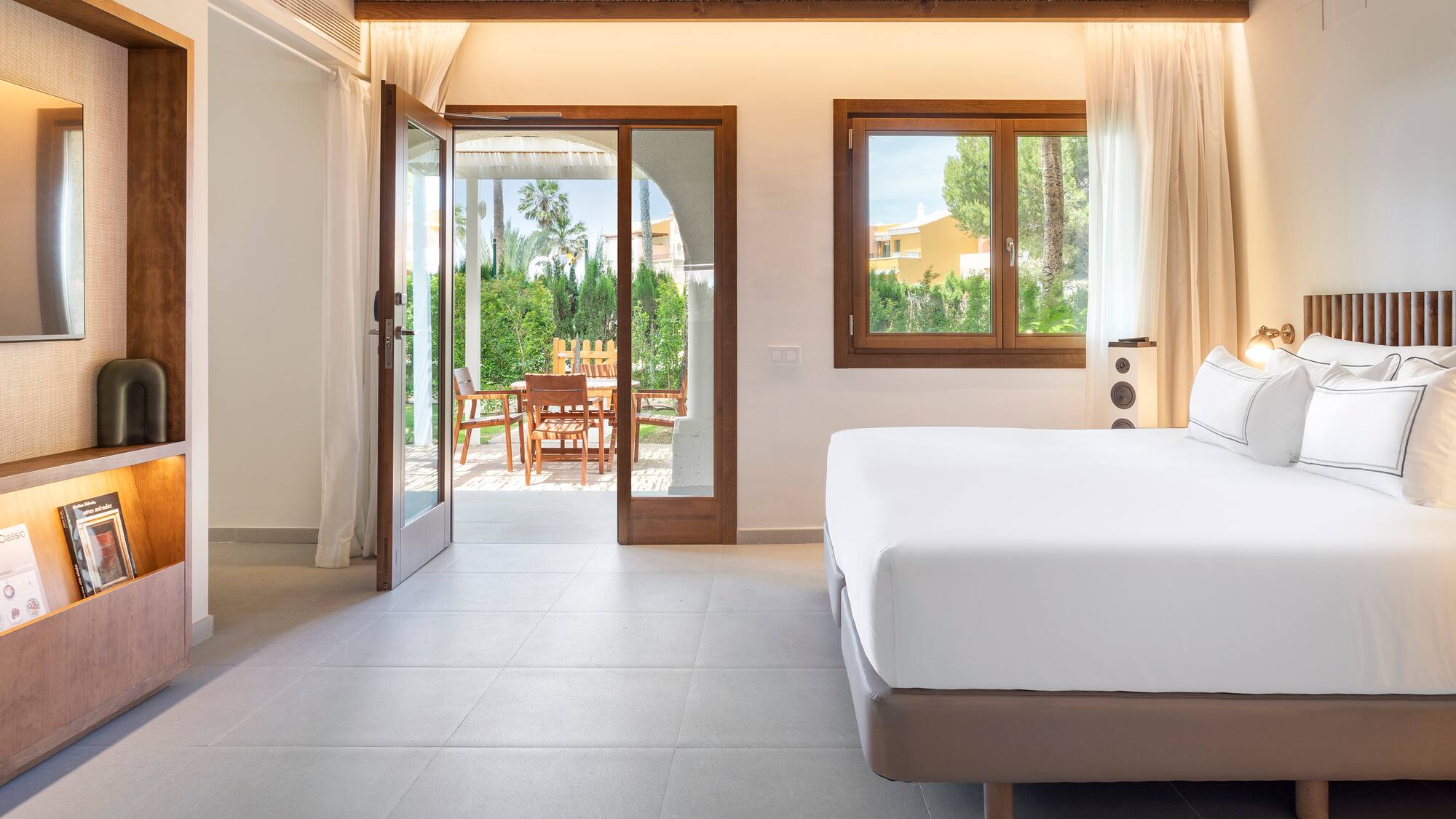 a bedroom with a bed and a glass door