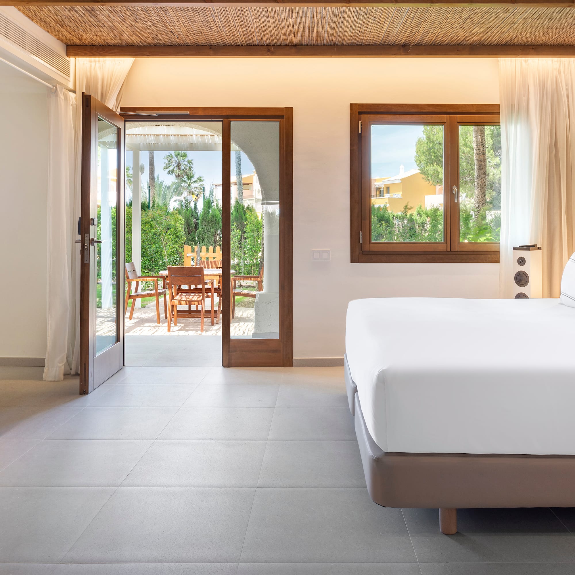 a bedroom with a bed and a glass door