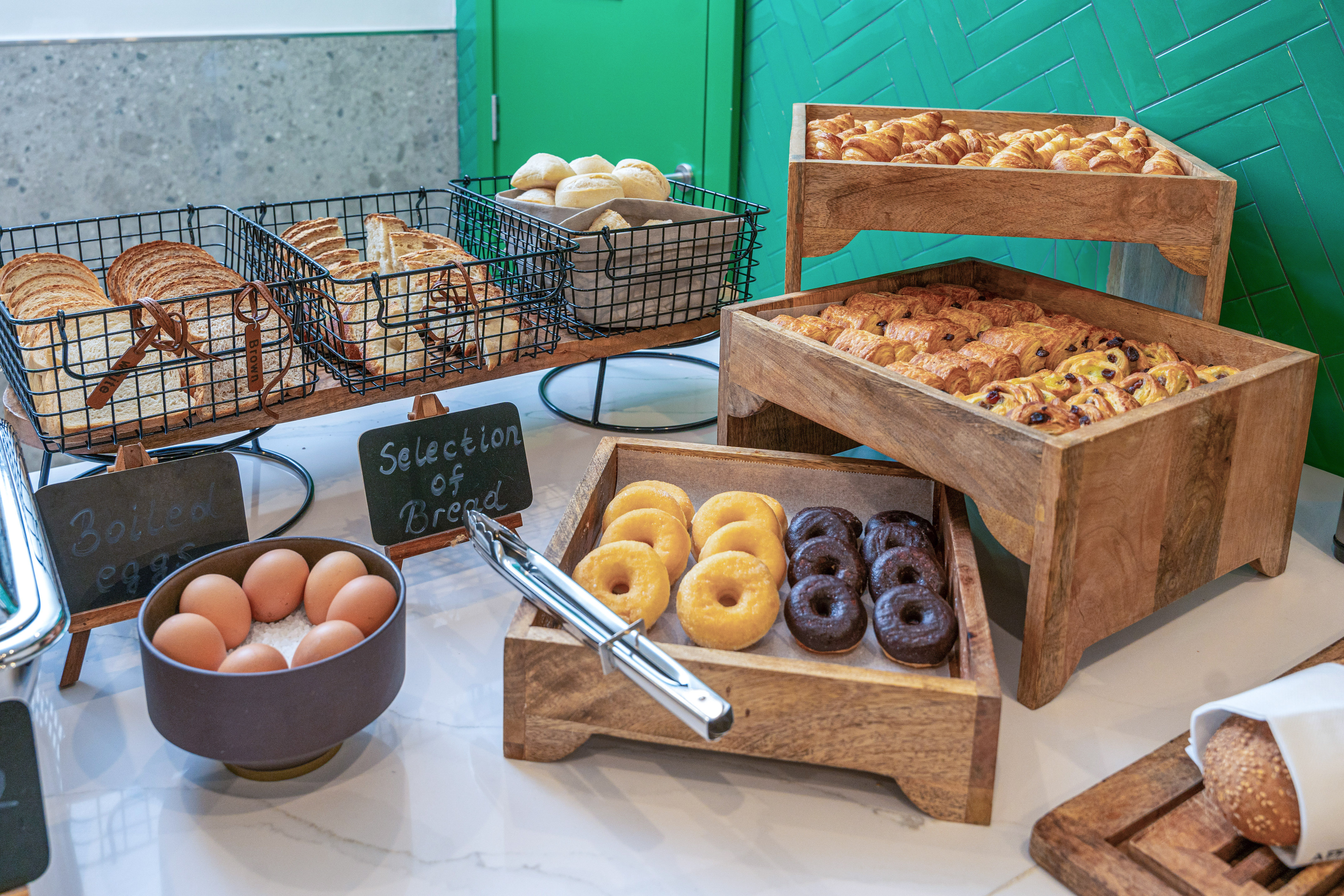 Hotel breakfast buffet: croissants, bread, donuts, boiled eggs.