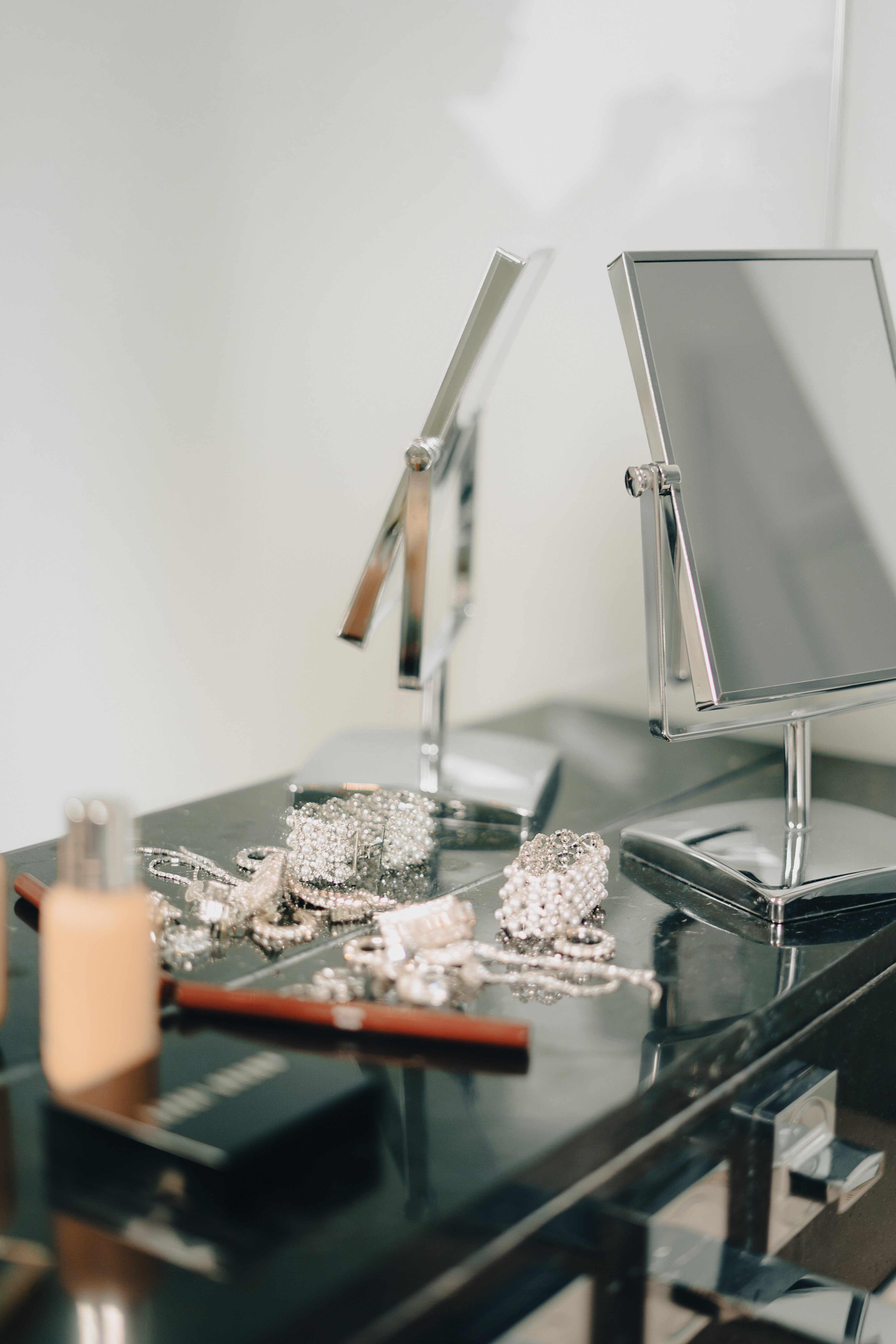 a mirror and jewelry on a counter