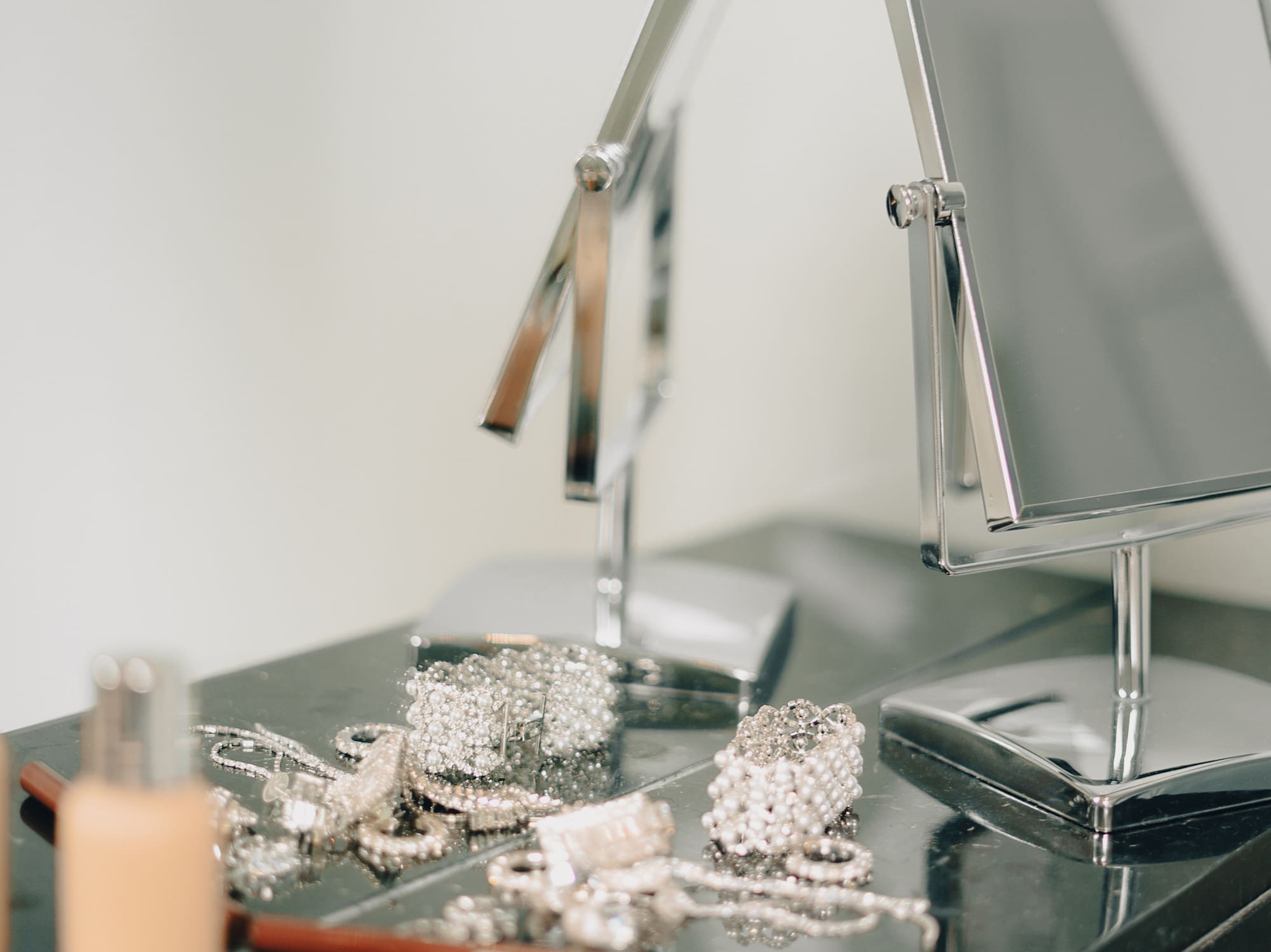 a mirror and jewelry on a counter