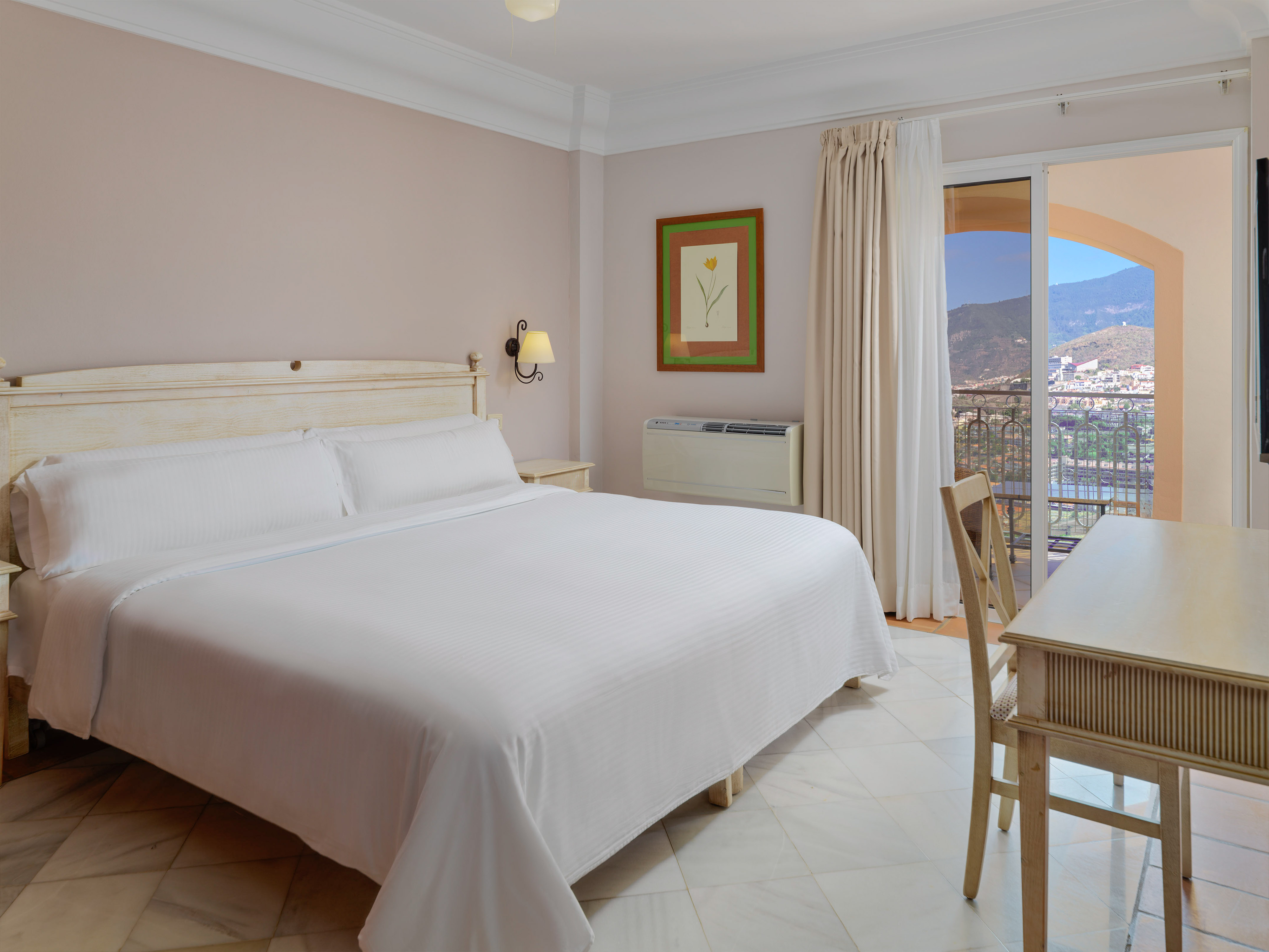 a bedroom with a bed and a table and chairs