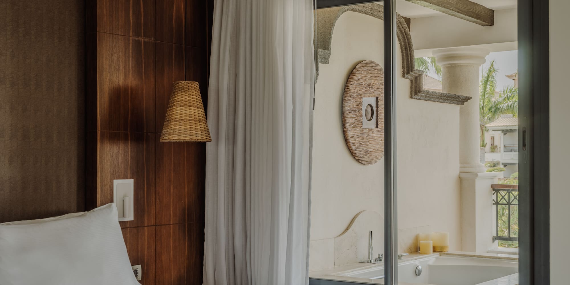 a bed in a room with a glass door