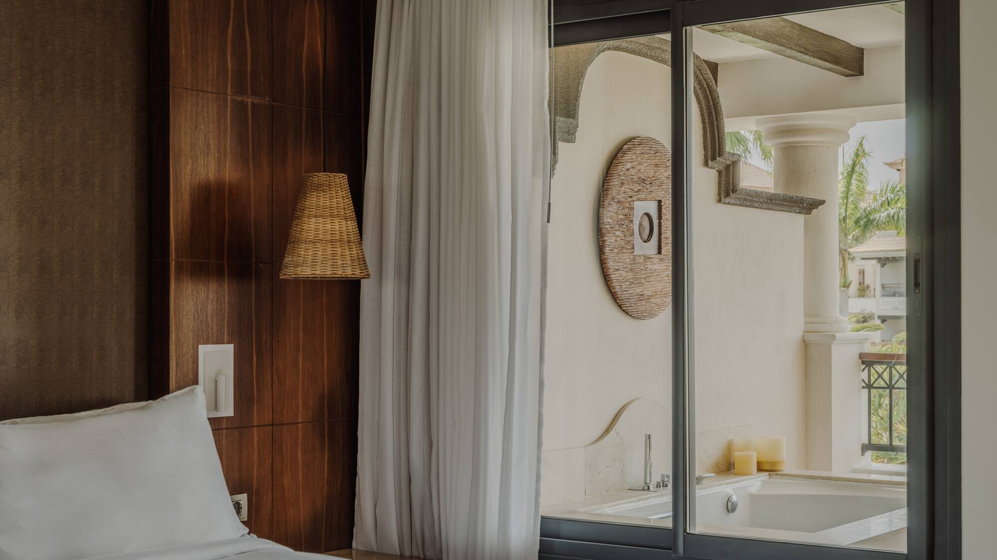 a bed in a room with a glass door