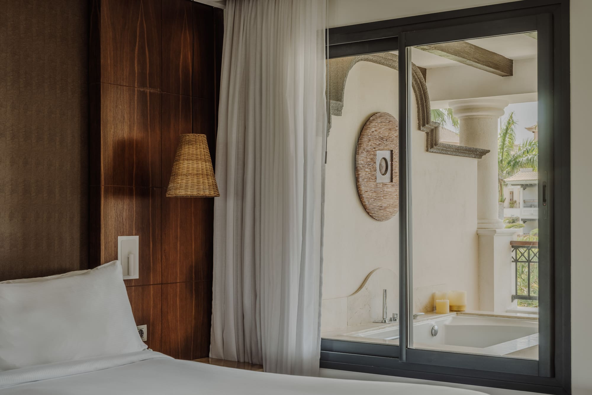 a bed in a room with a glass door