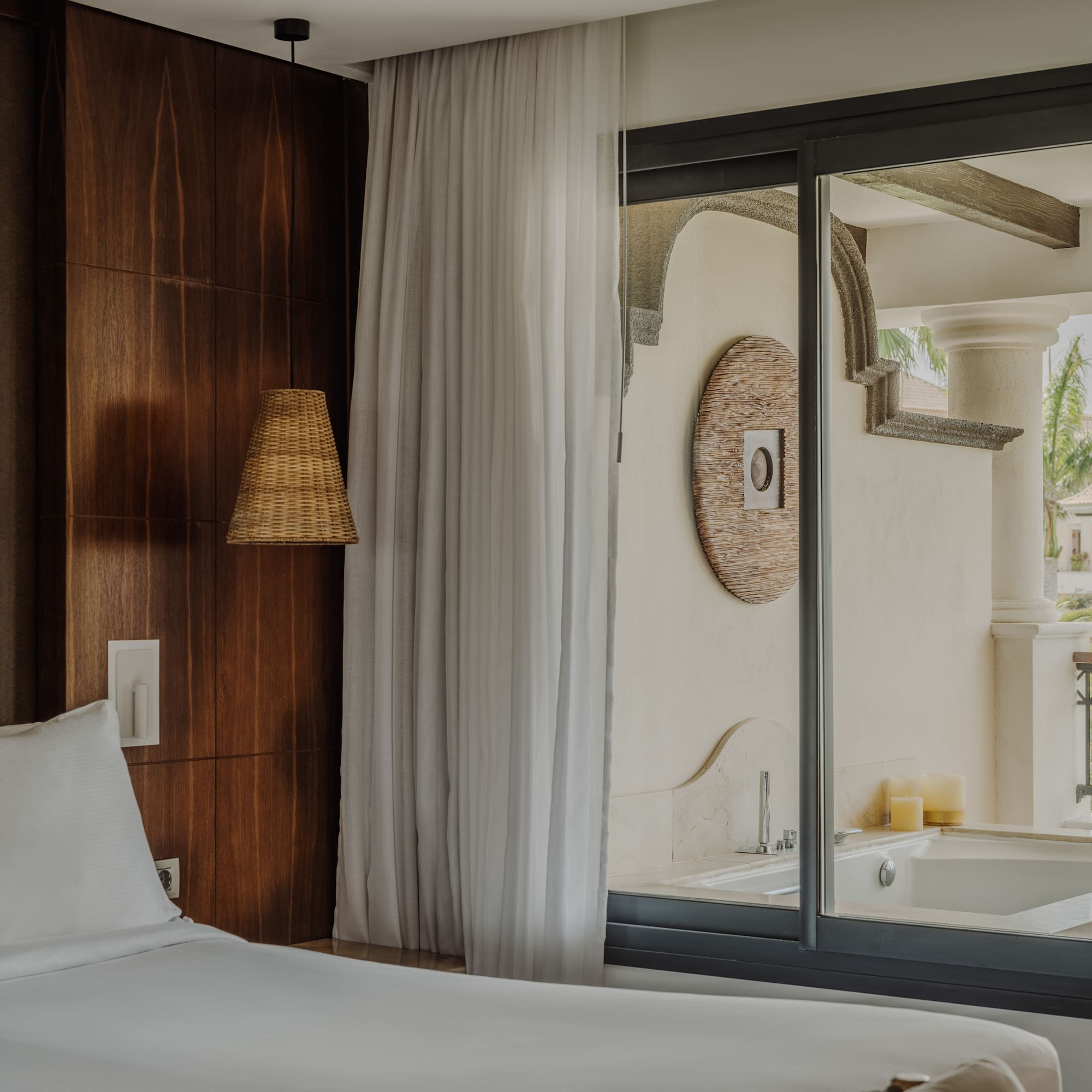 a bed in a room with a glass door