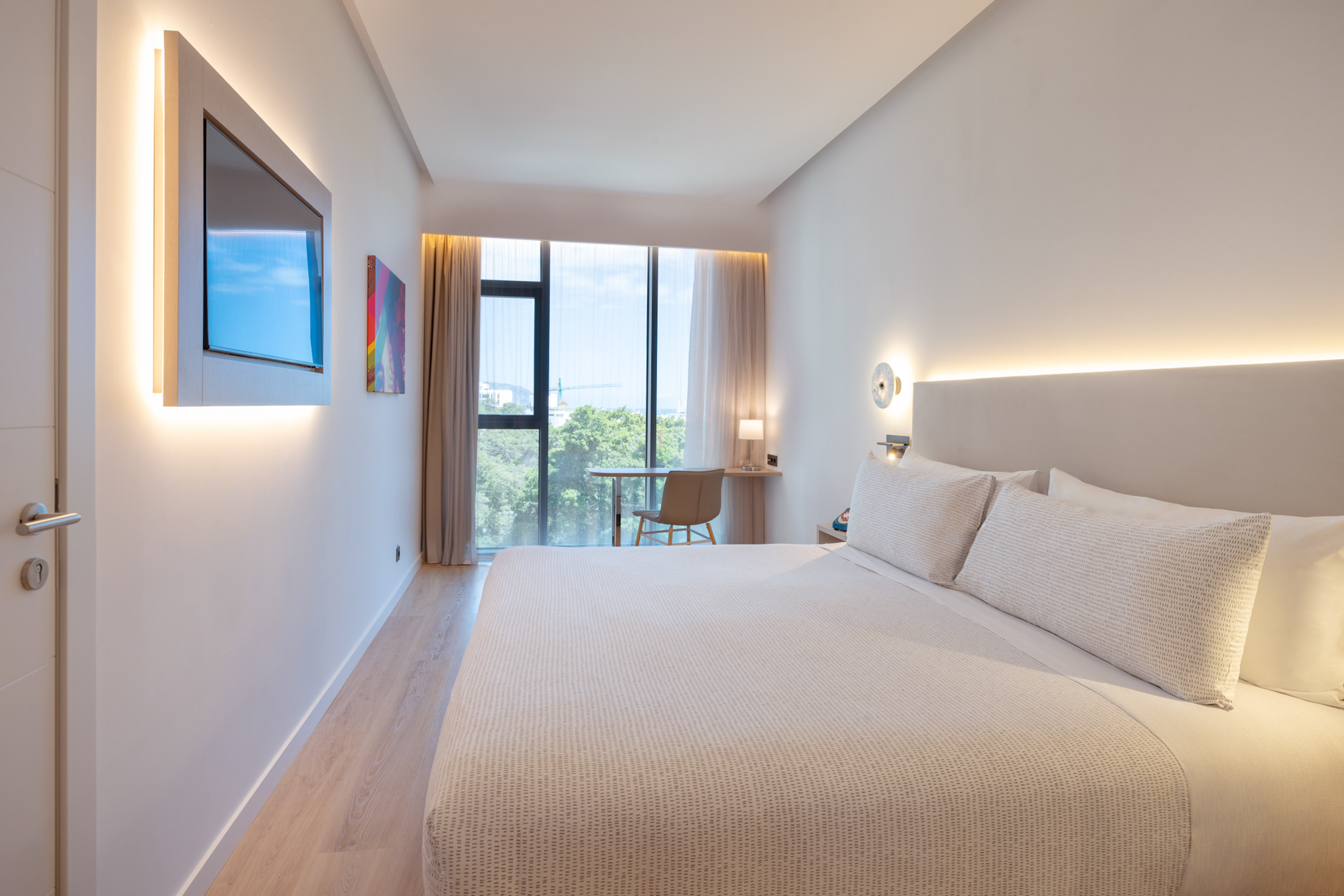 a bed in a room with a window and a table