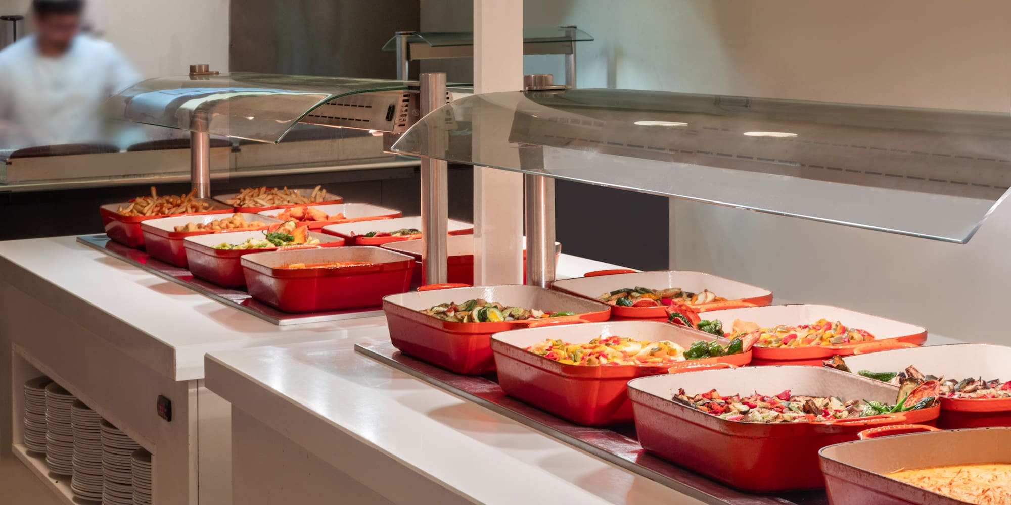 a row of red containers with food in them