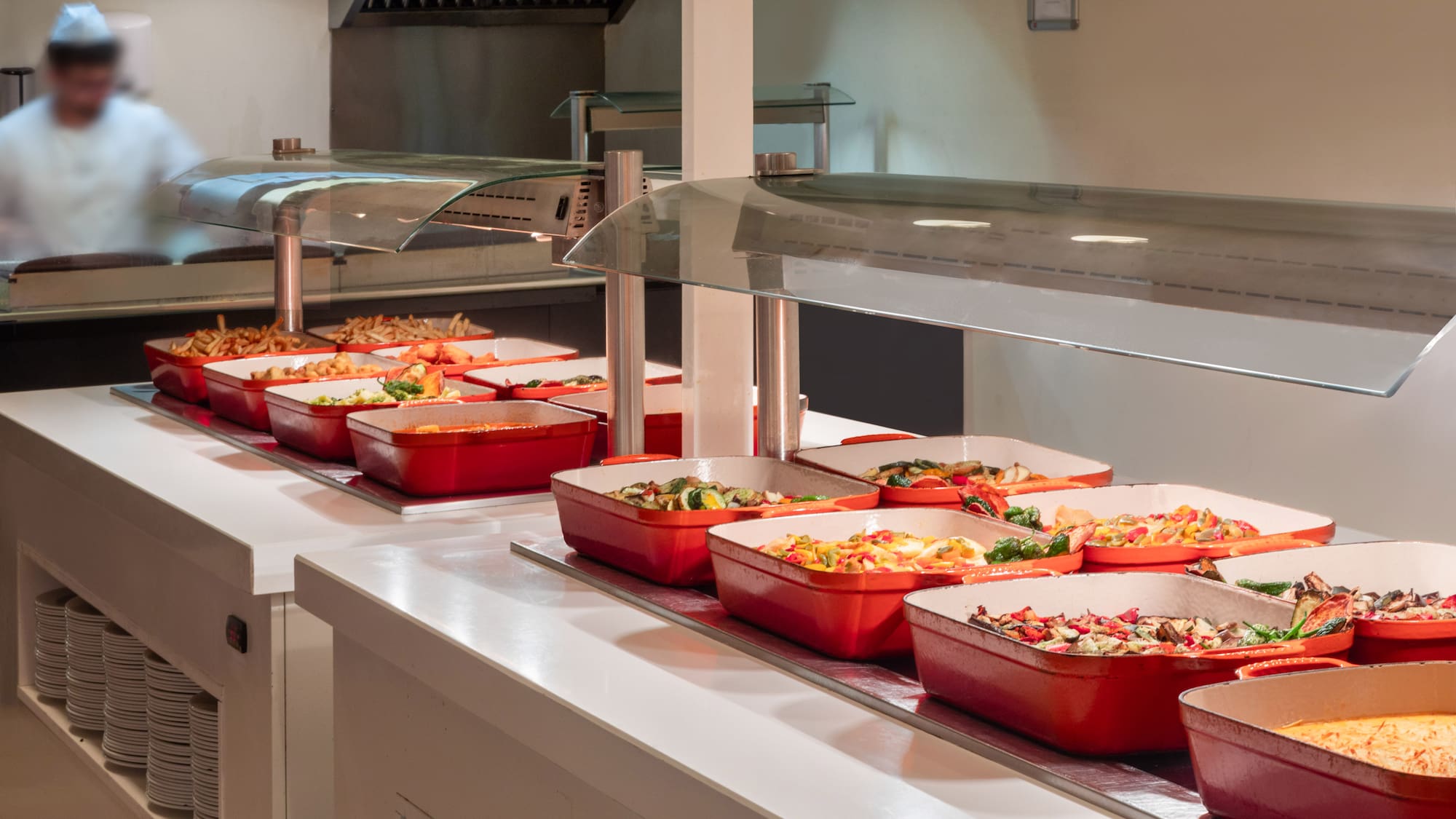 a row of red containers with food in them