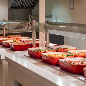 a row of red containers with food in them