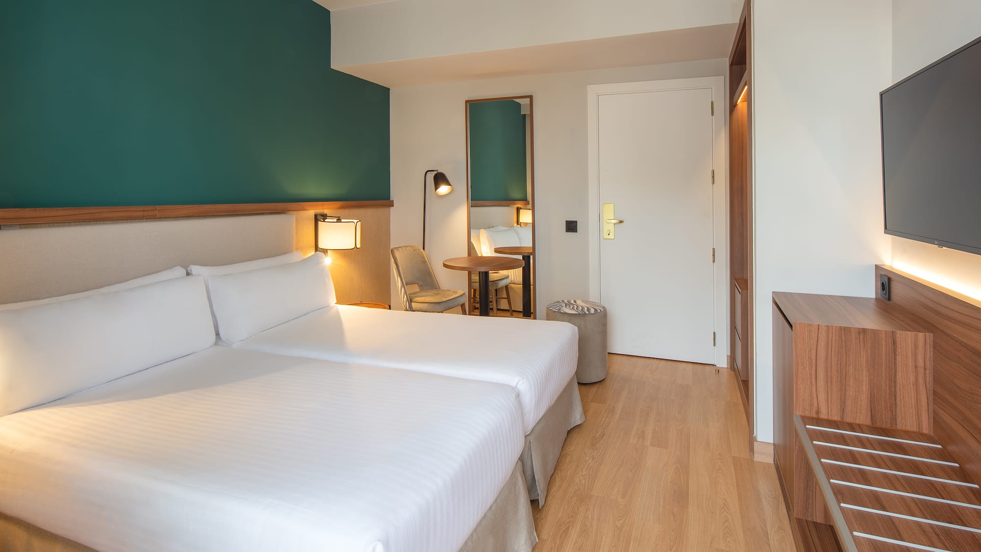 a room with two beds and a table and a chair