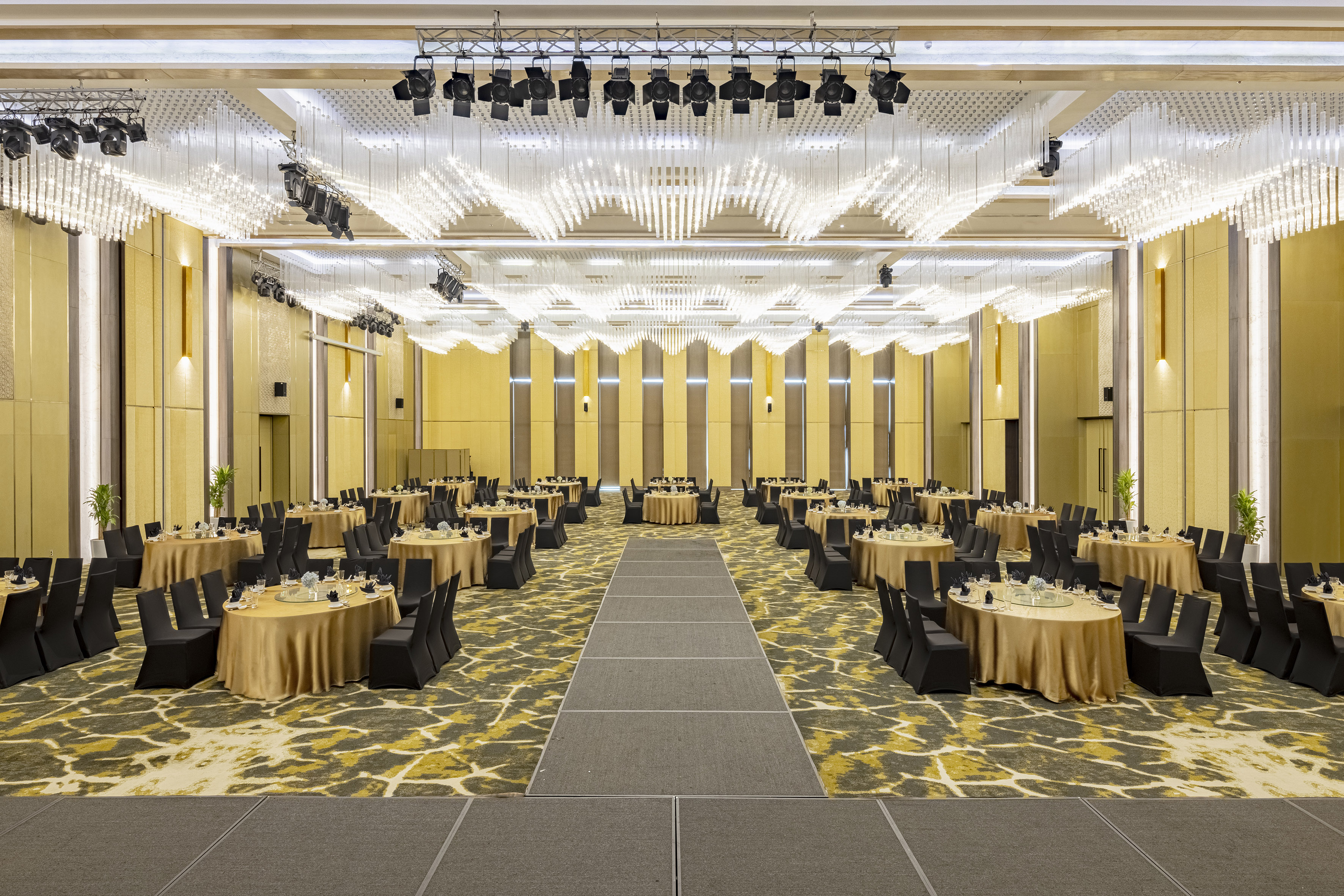 Elegant ballroom with gold tables, black chairs, and modern chandeliers. - Grand Ballroom - Meliá Vinpearl Thanh Hoa, Thanh Hoa