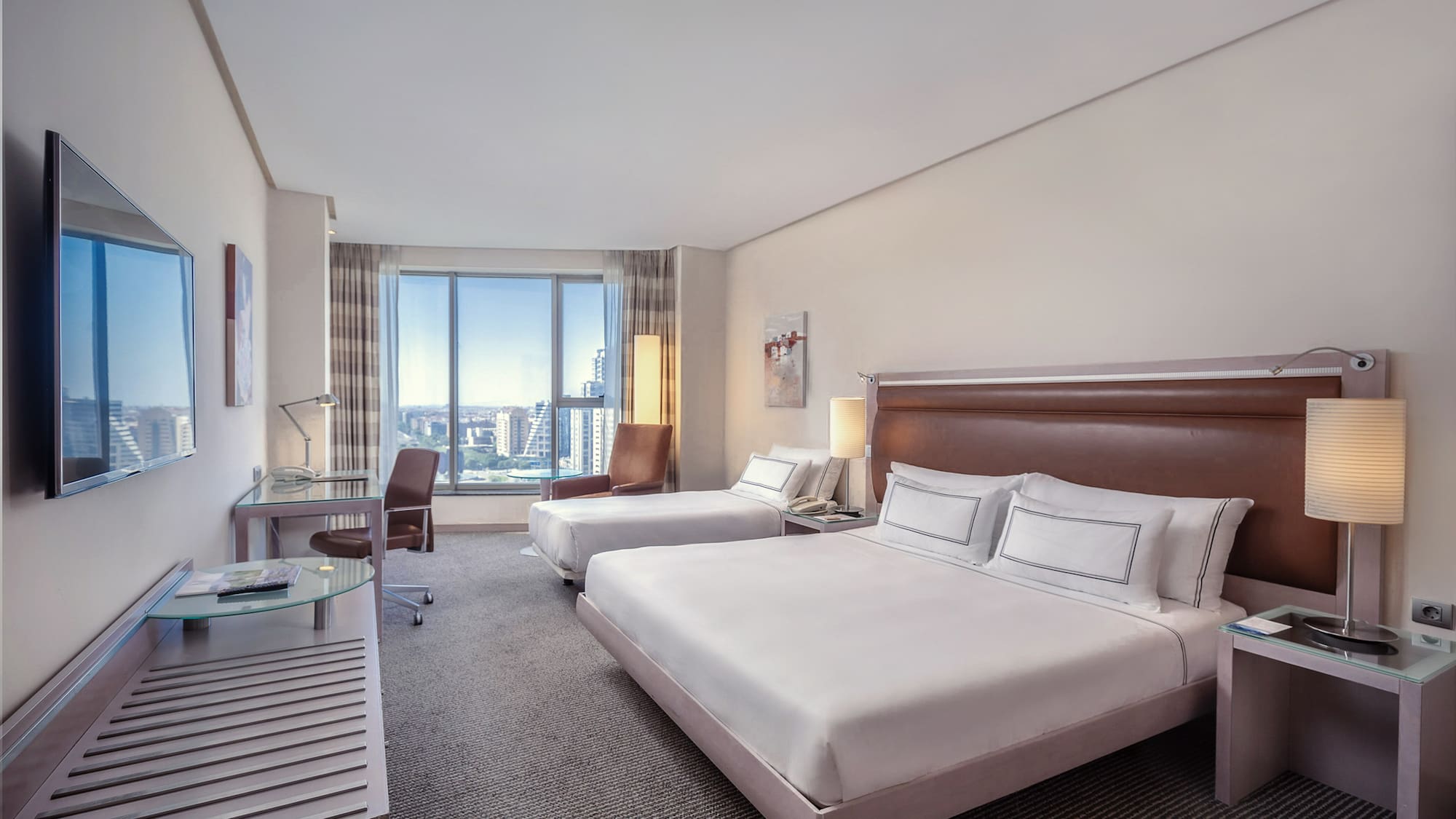 a hotel room with two beds and a desk