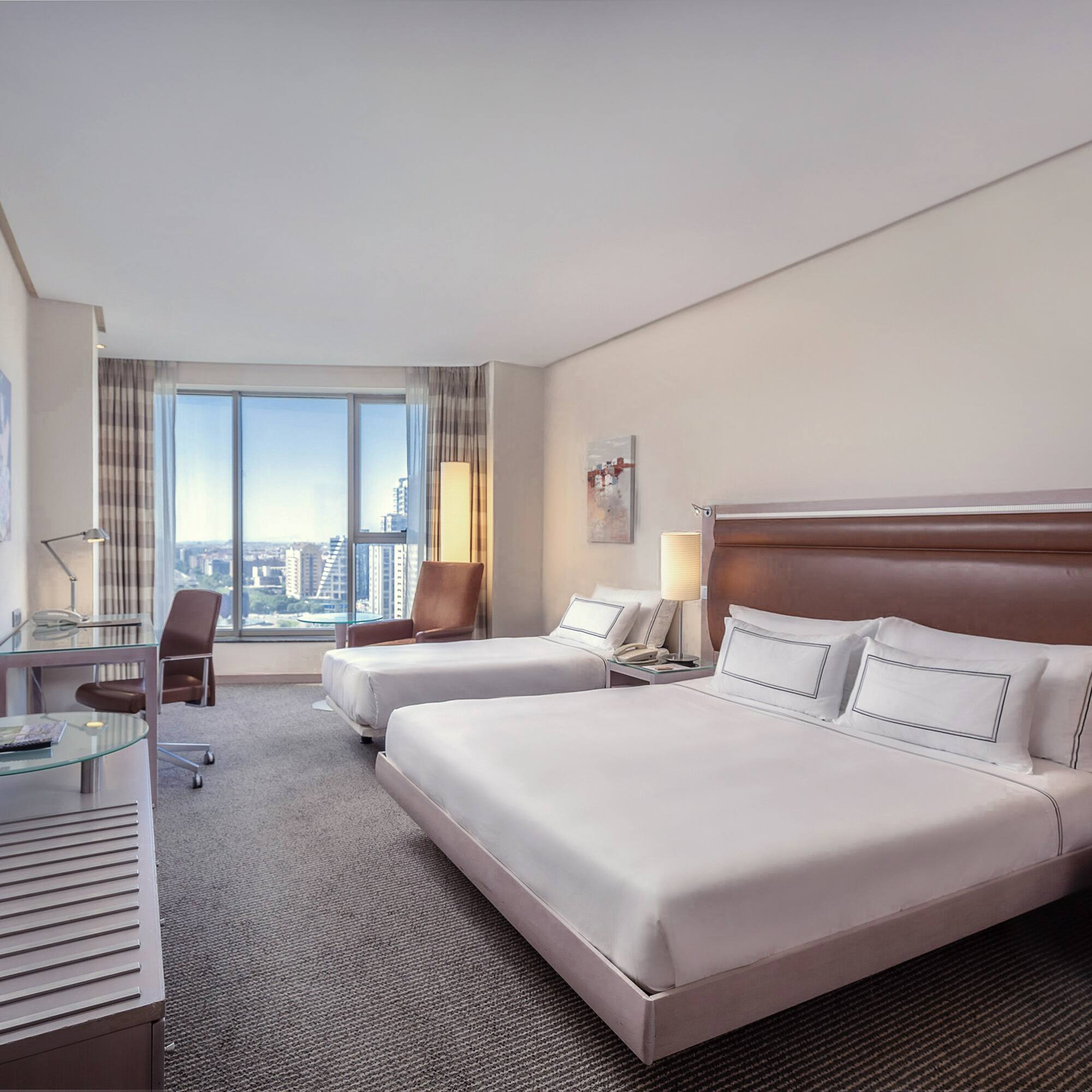 a hotel room with two beds and a desk