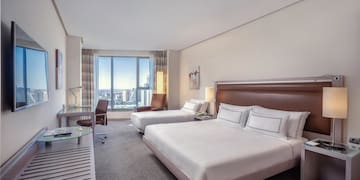 a hotel room with two beds and a desk