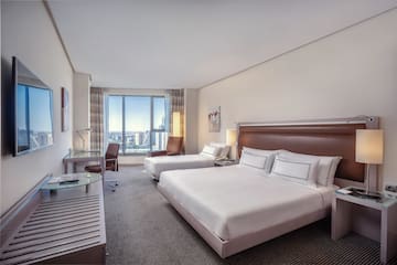 a hotel room with two beds and a desk