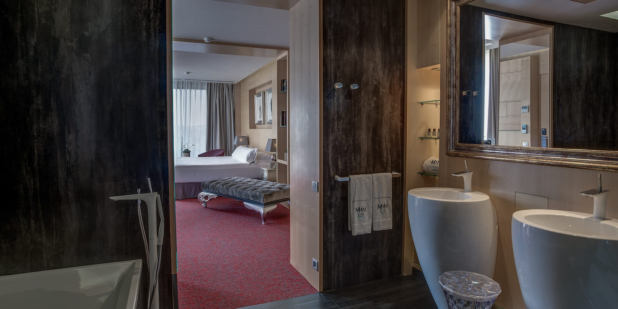 a bathroom with a mirror and a bed