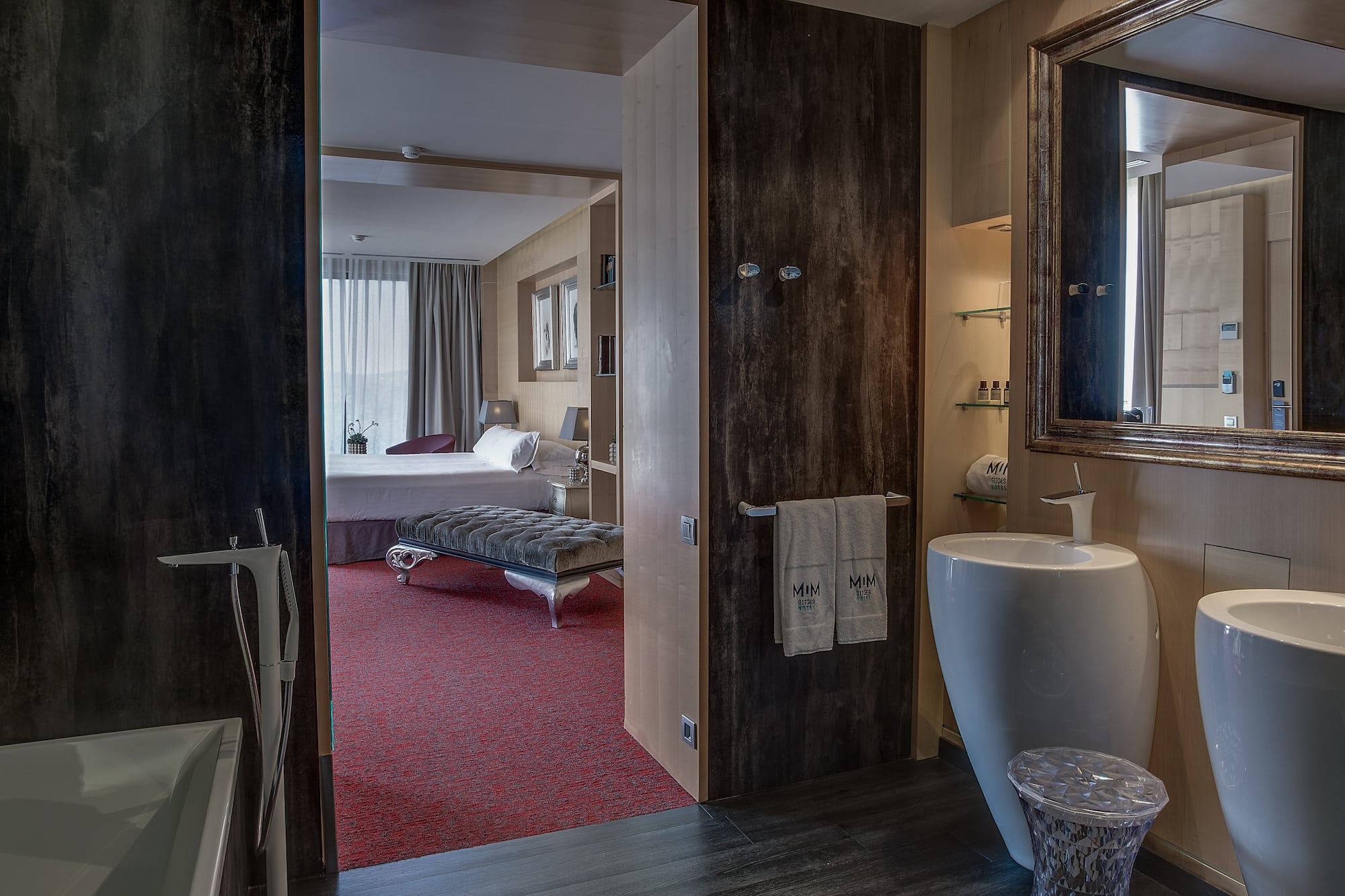 a bathroom with a mirror and a bed