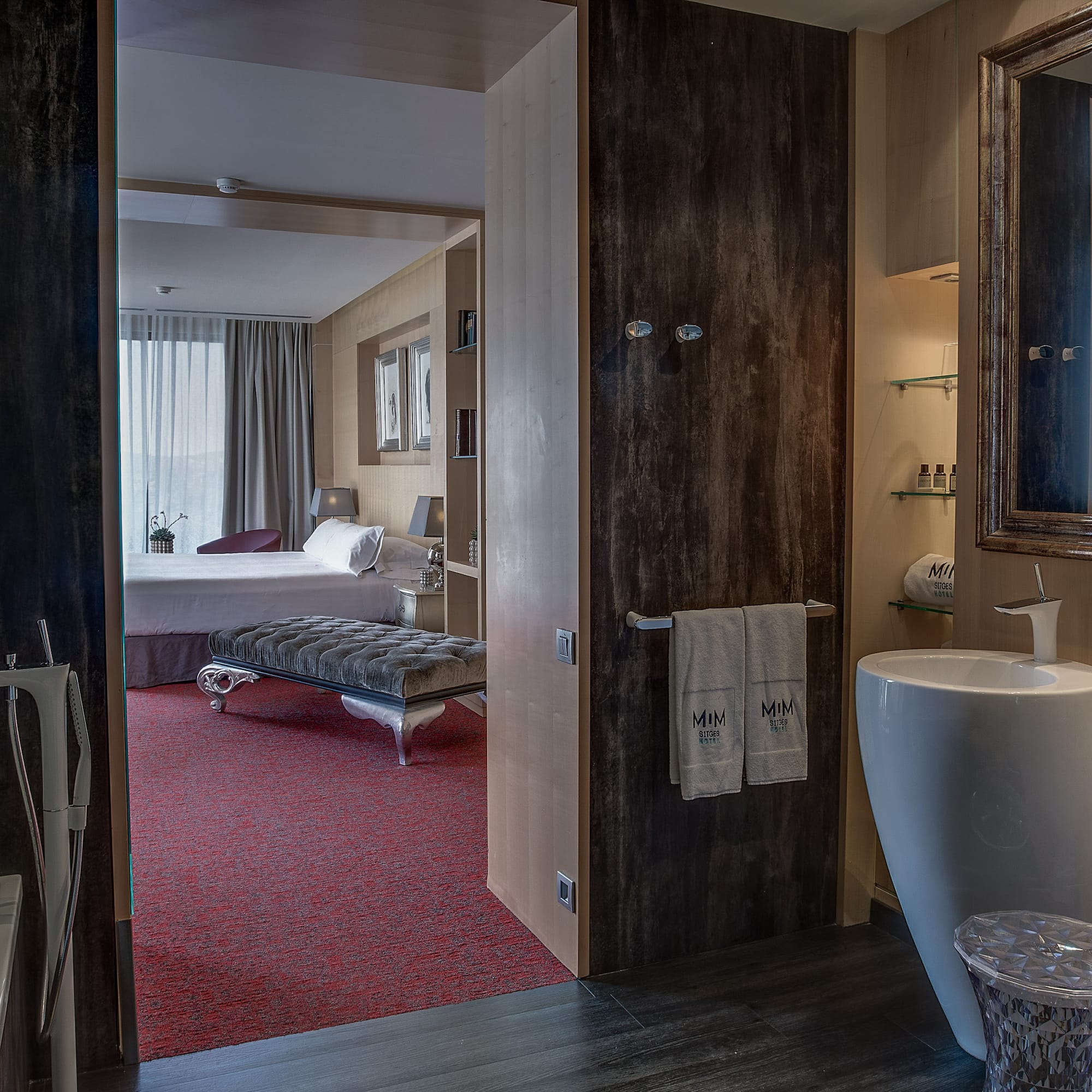 a bathroom with a mirror and a bed