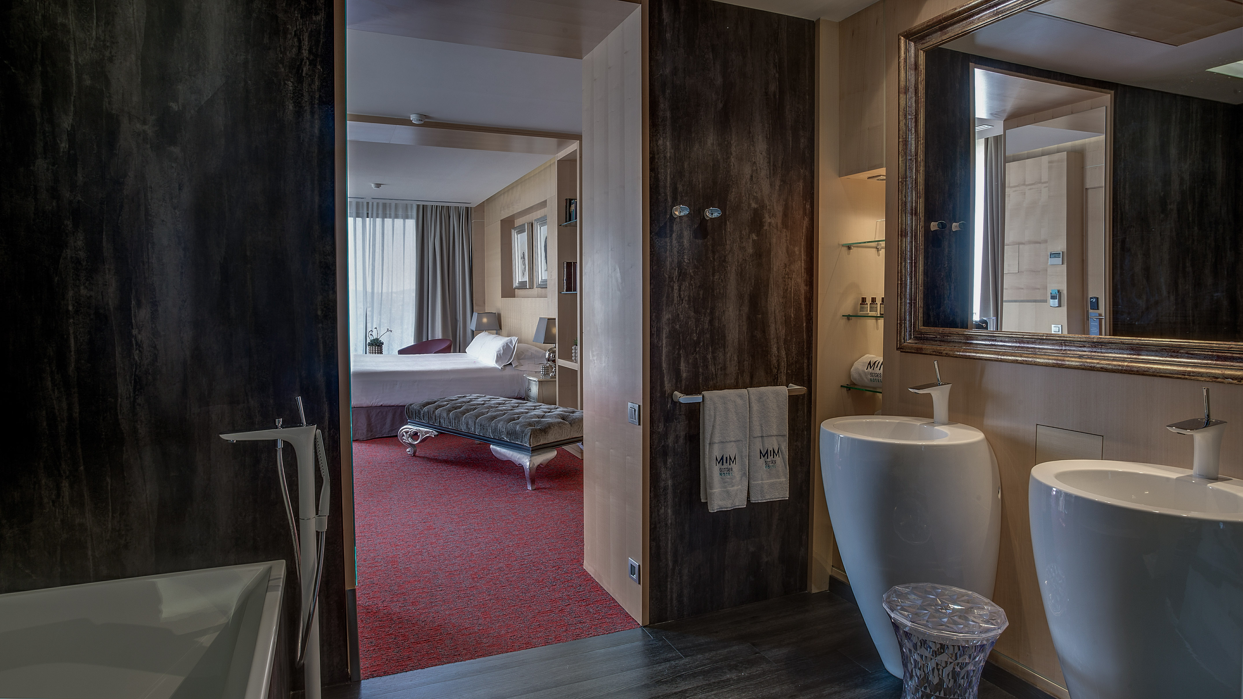 a bathroom with a mirror and a bed