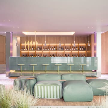 a bar with a green couch and a green bar counter