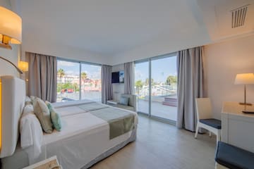 a bedroom with a large window