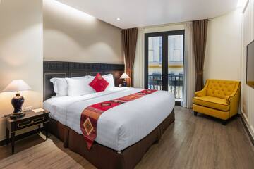 a bedroom with a bed and a yellow chair