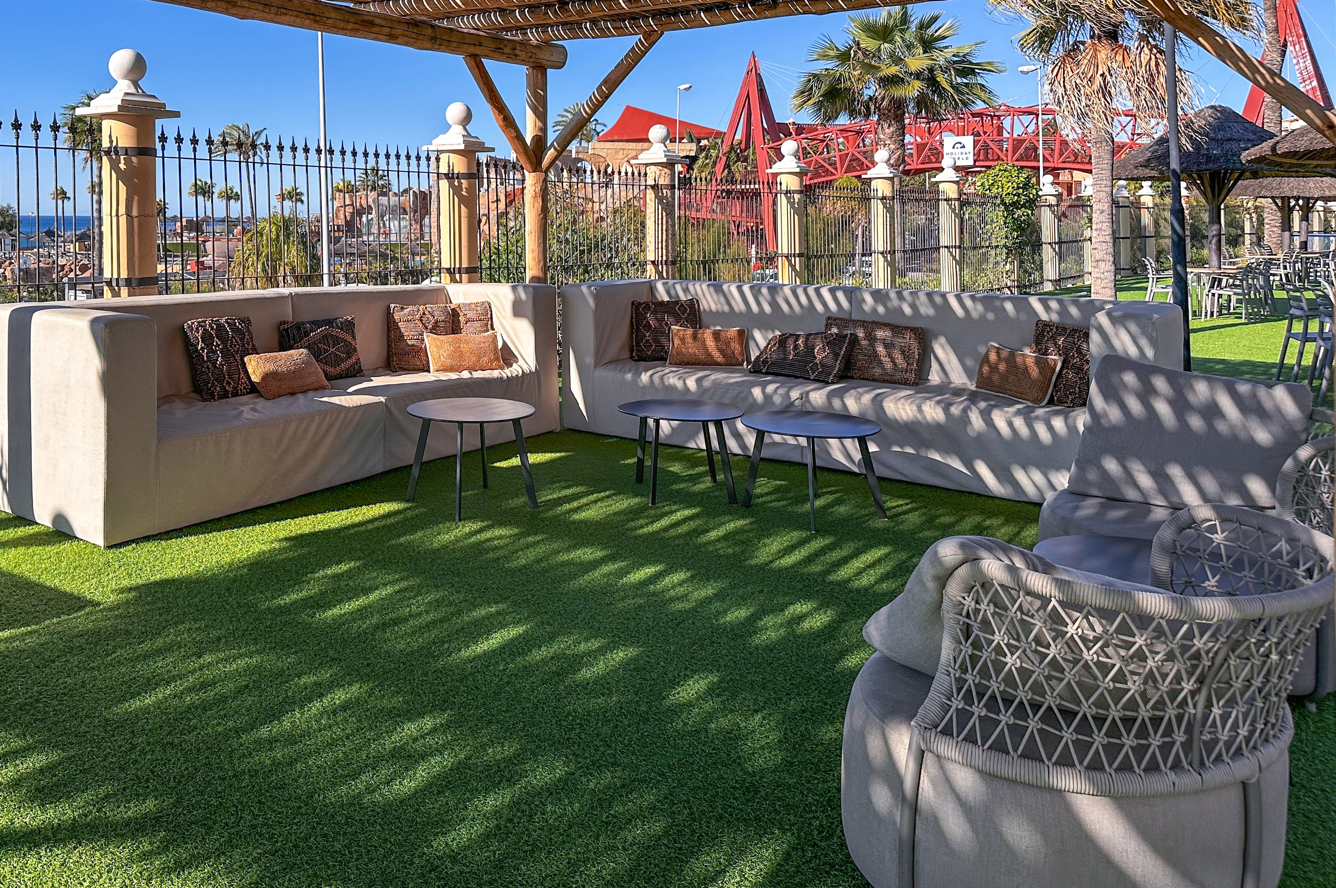 a patio with a couch and tables