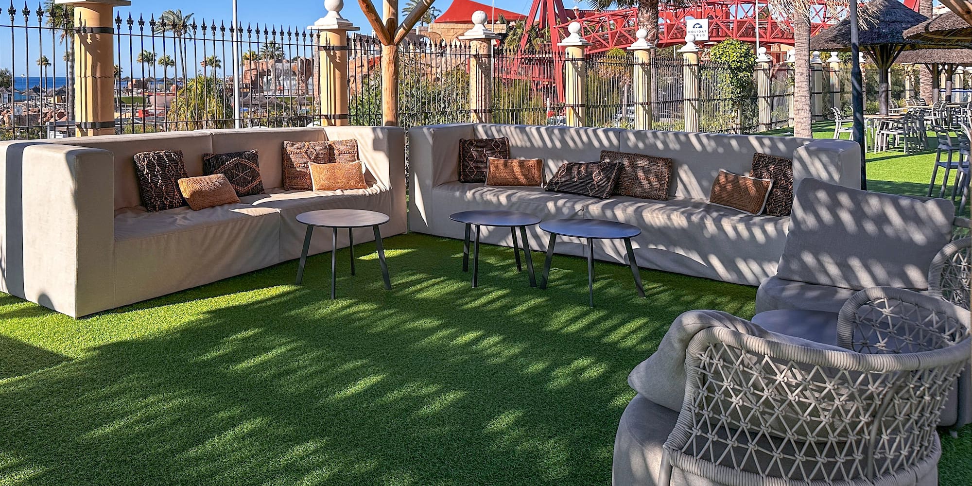 a patio with a couch and tables