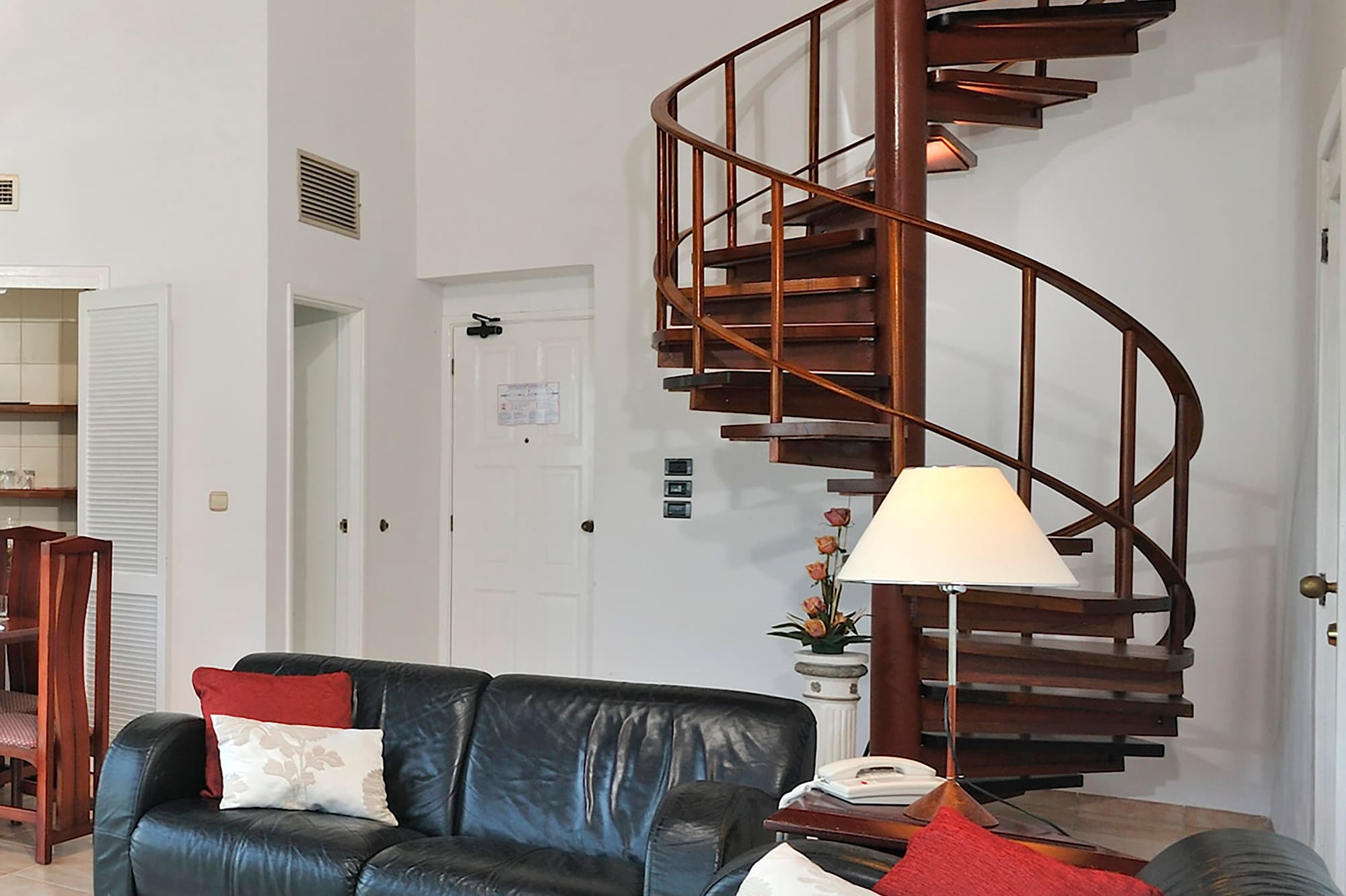 a spiral staircase in a room with a couch and a couch