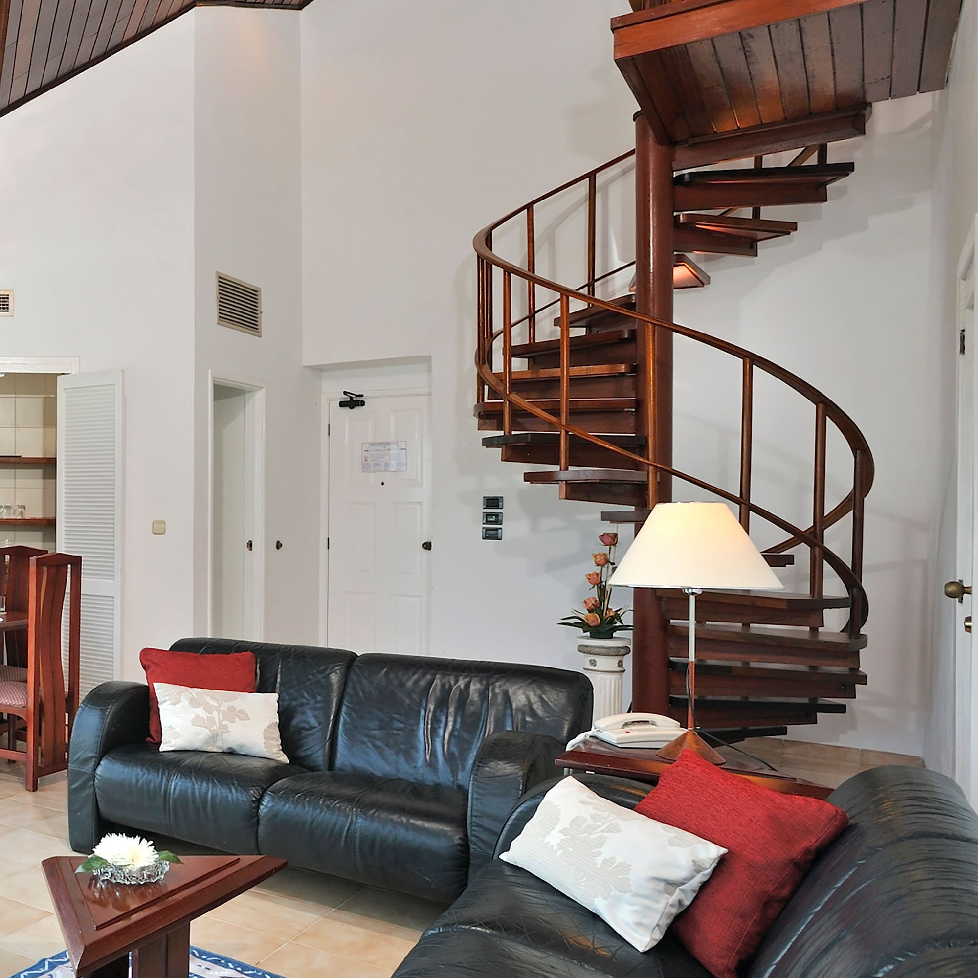 a spiral staircase in a room with a couch and a couch