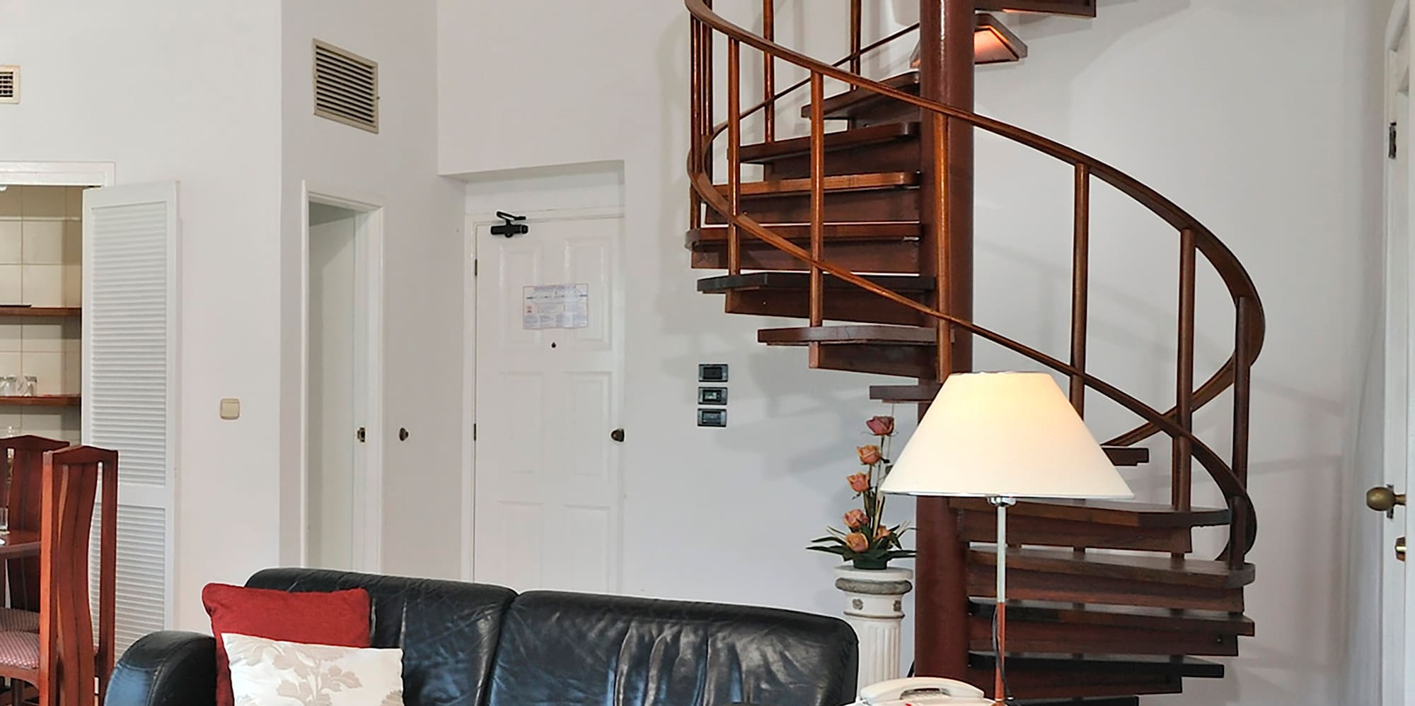 a spiral staircase in a room with a couch and a couch