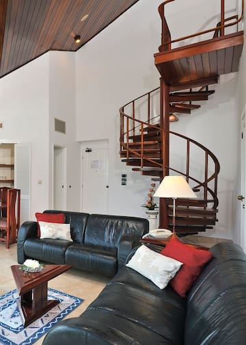 a spiral staircase in a room with a couch and a couch