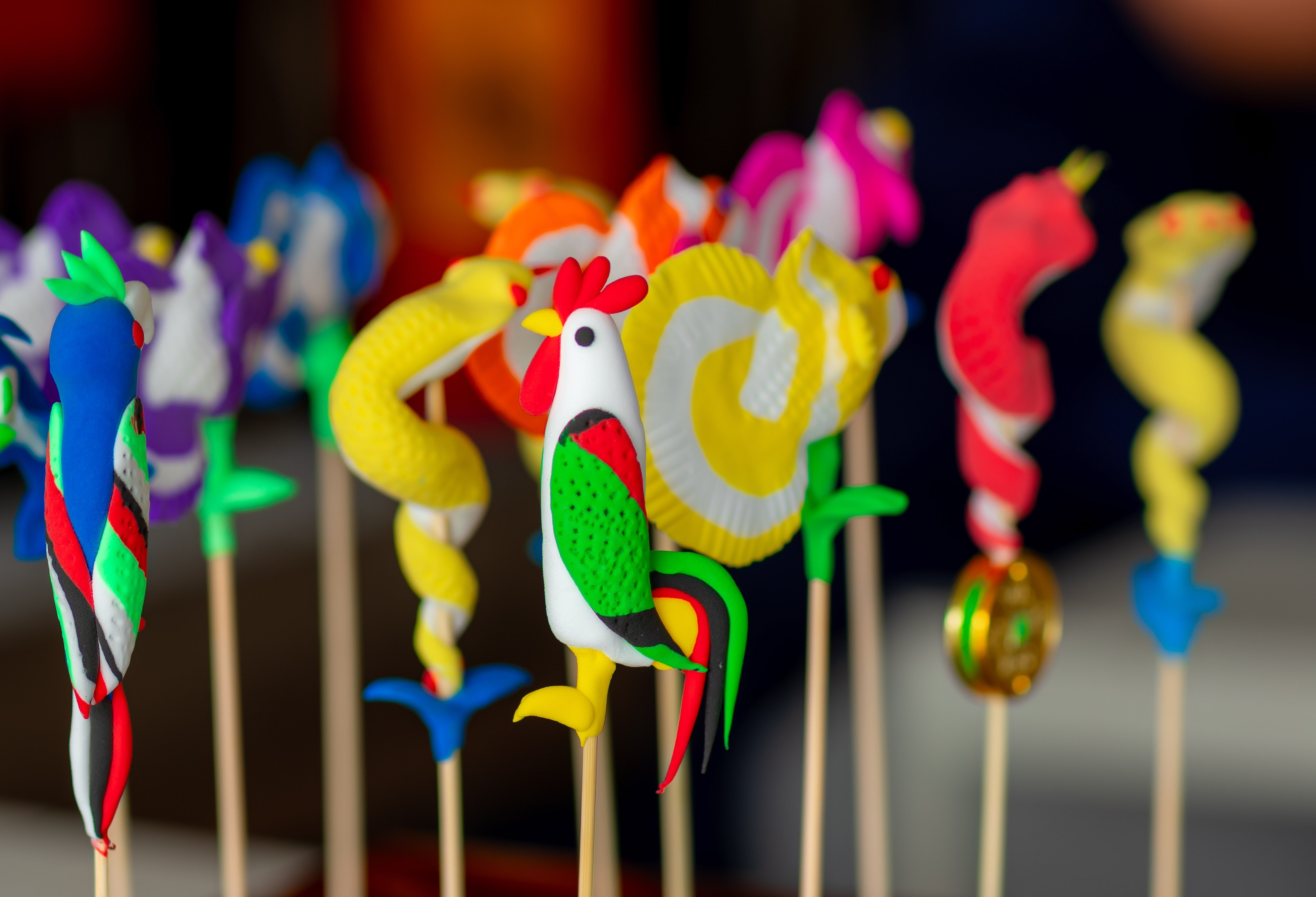 a group of colorful objects on sticks