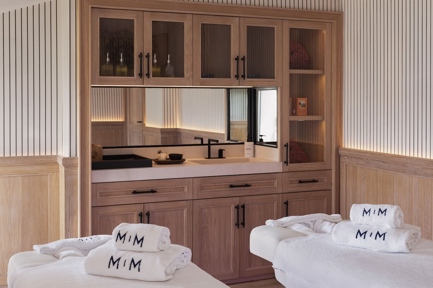 a room with white towels and a mirror
