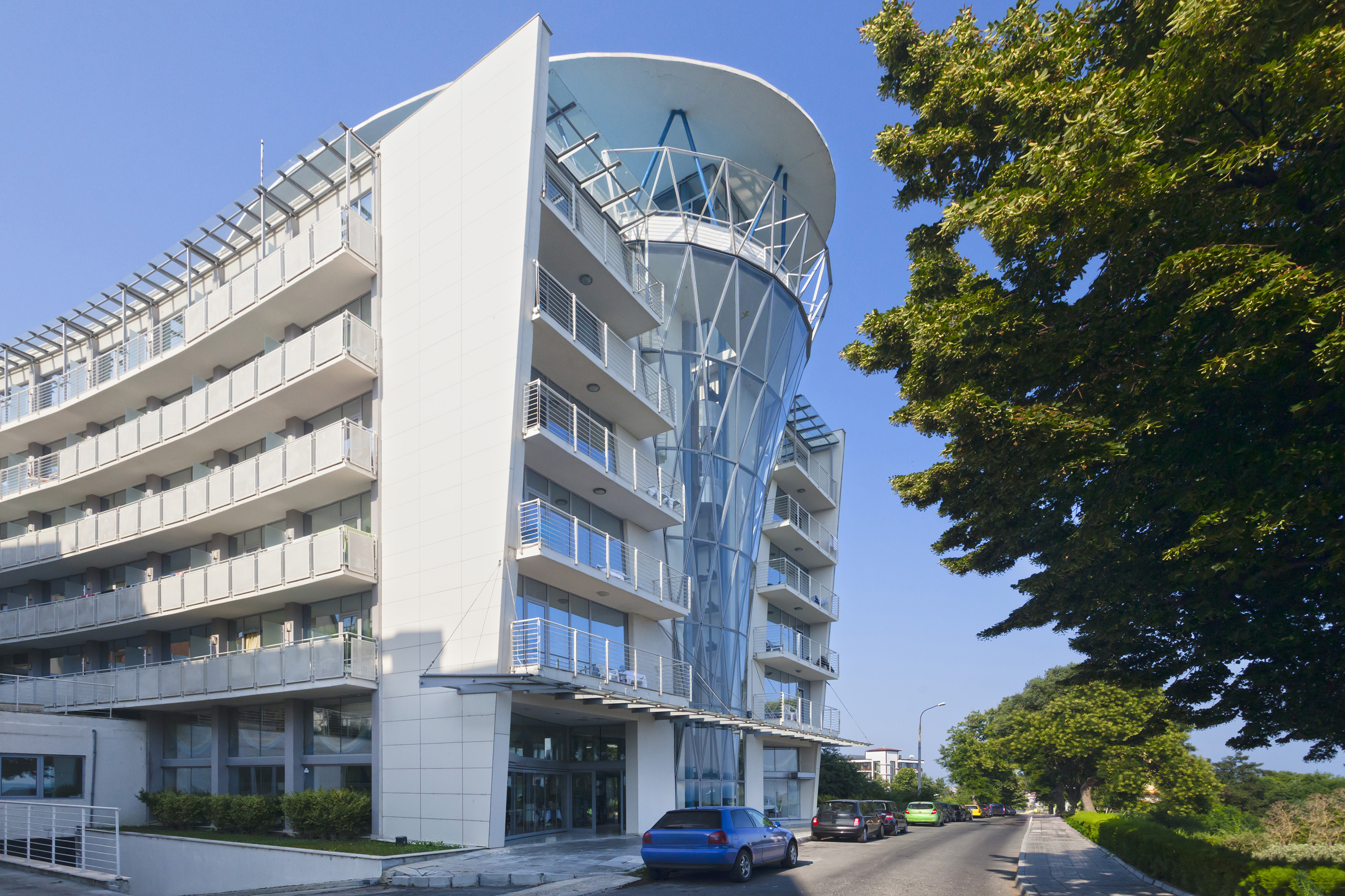 a building with a curved roof and a parking lot