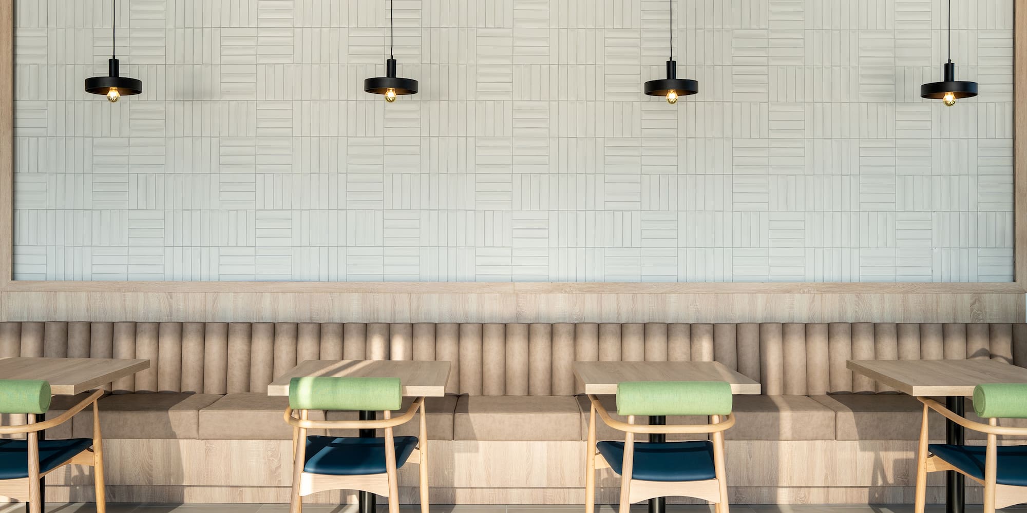 a booth seating with chairs and a light fixture