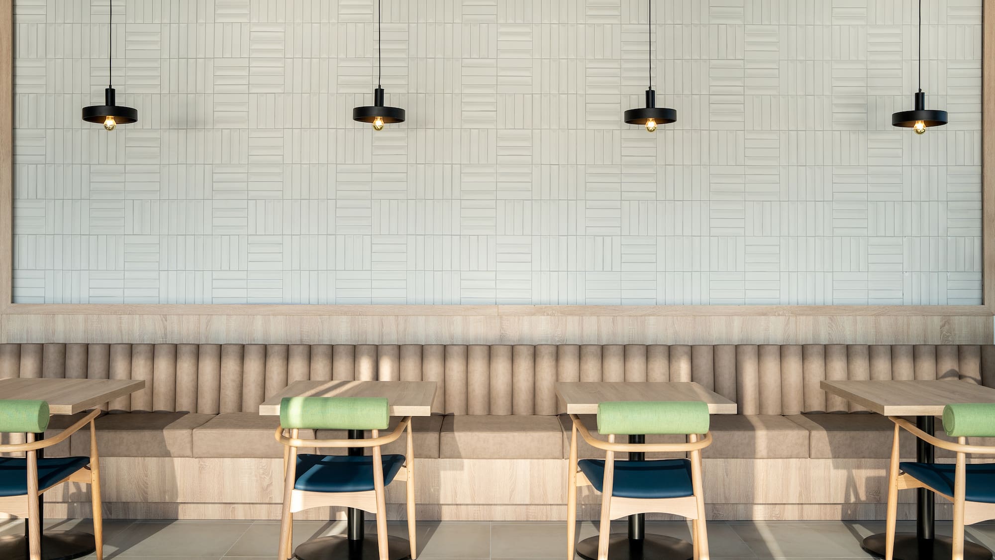 a booth seating with chairs and a light fixture
