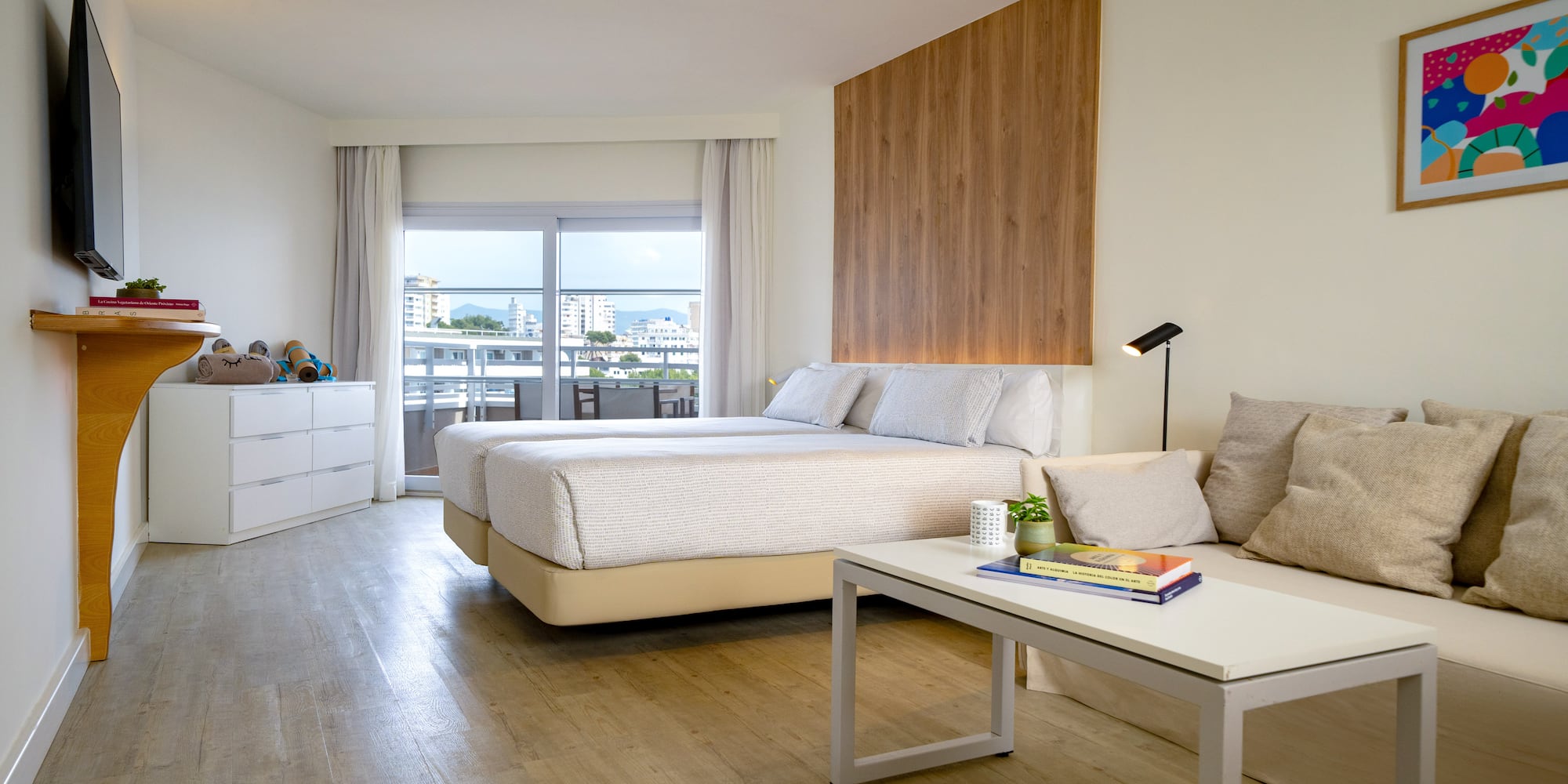 a room with two beds and a table