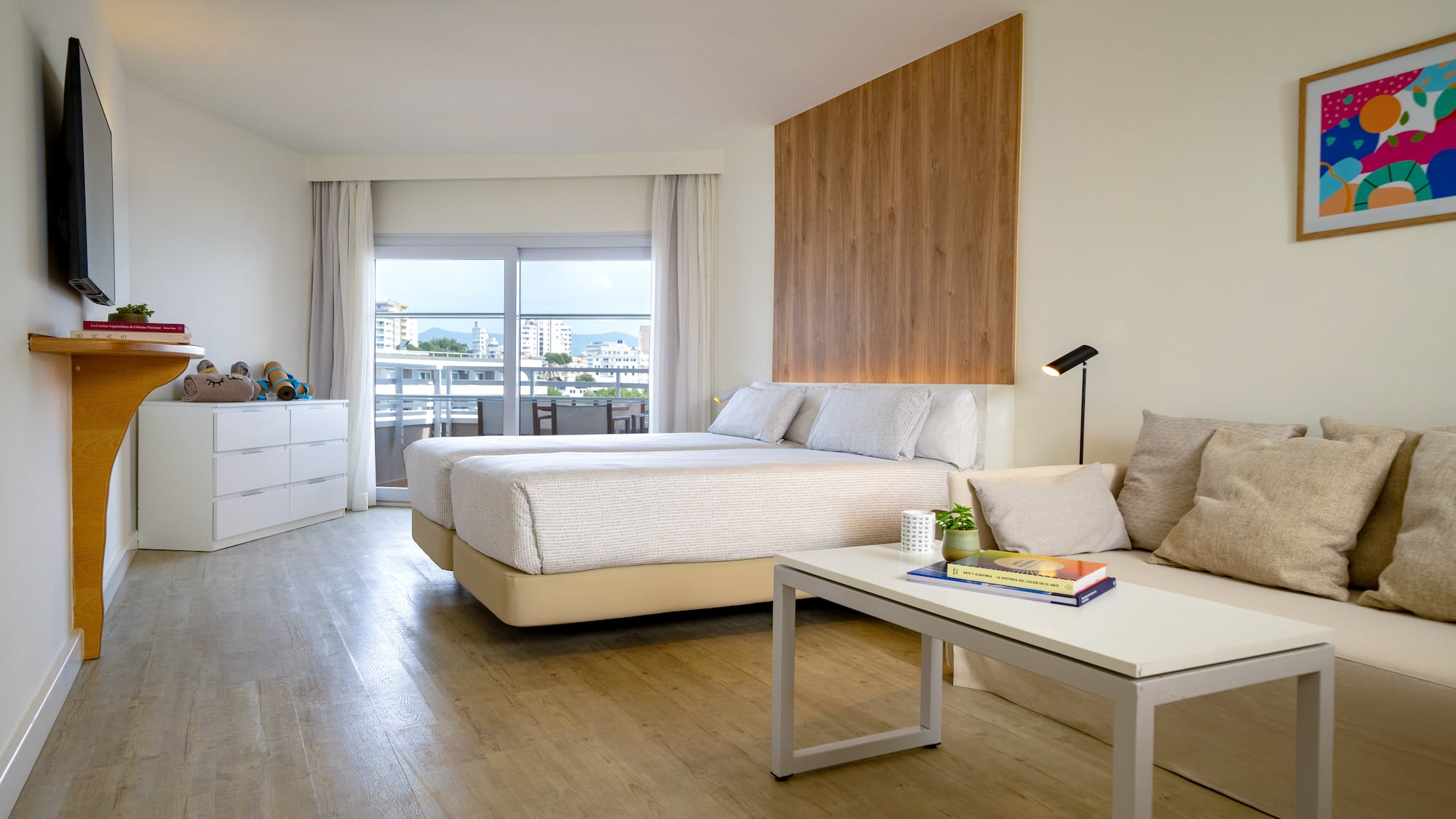 a room with two beds and a table