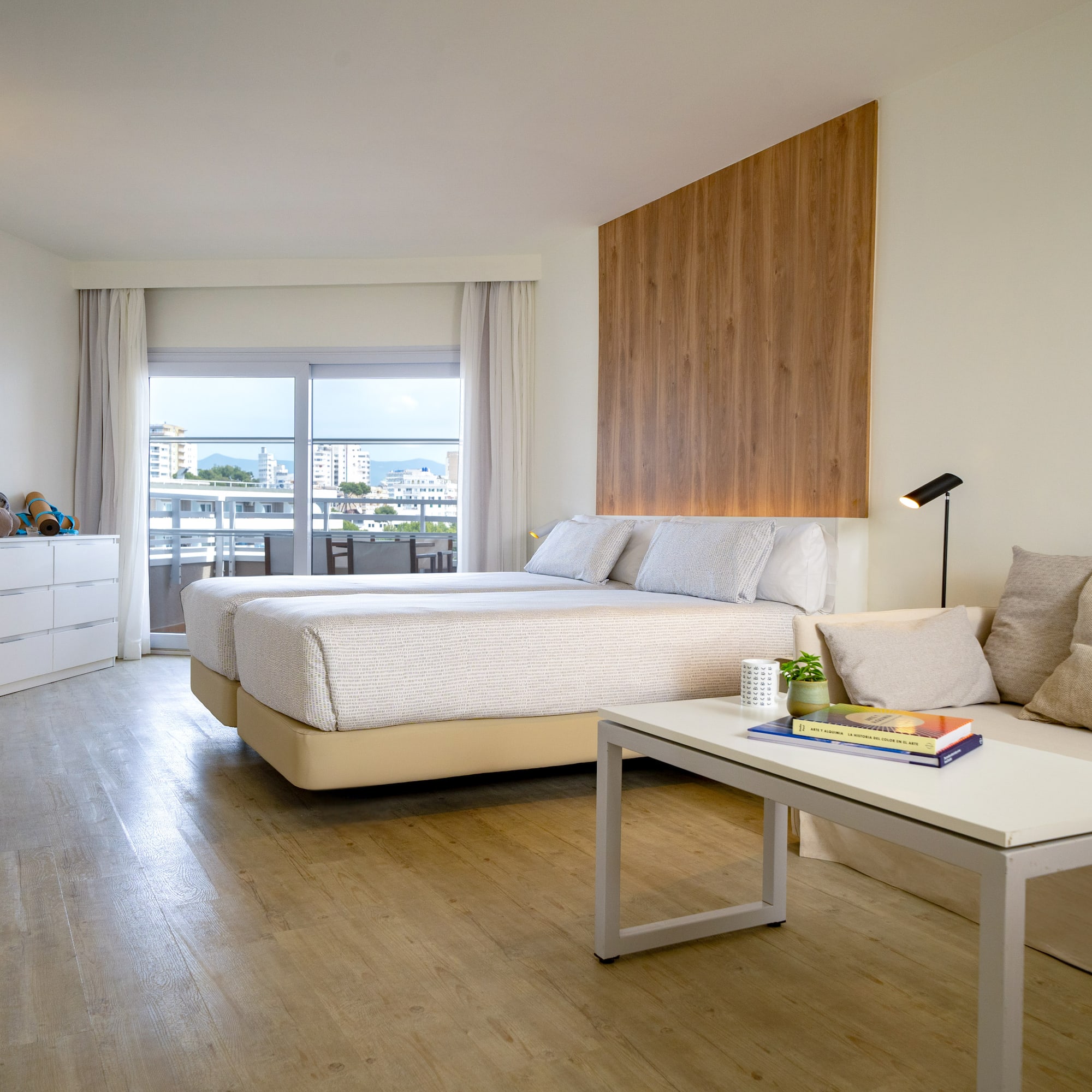 a room with two beds and a table