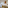 Modern hotel room with twin beds, sofa, balcony city view, wood details.